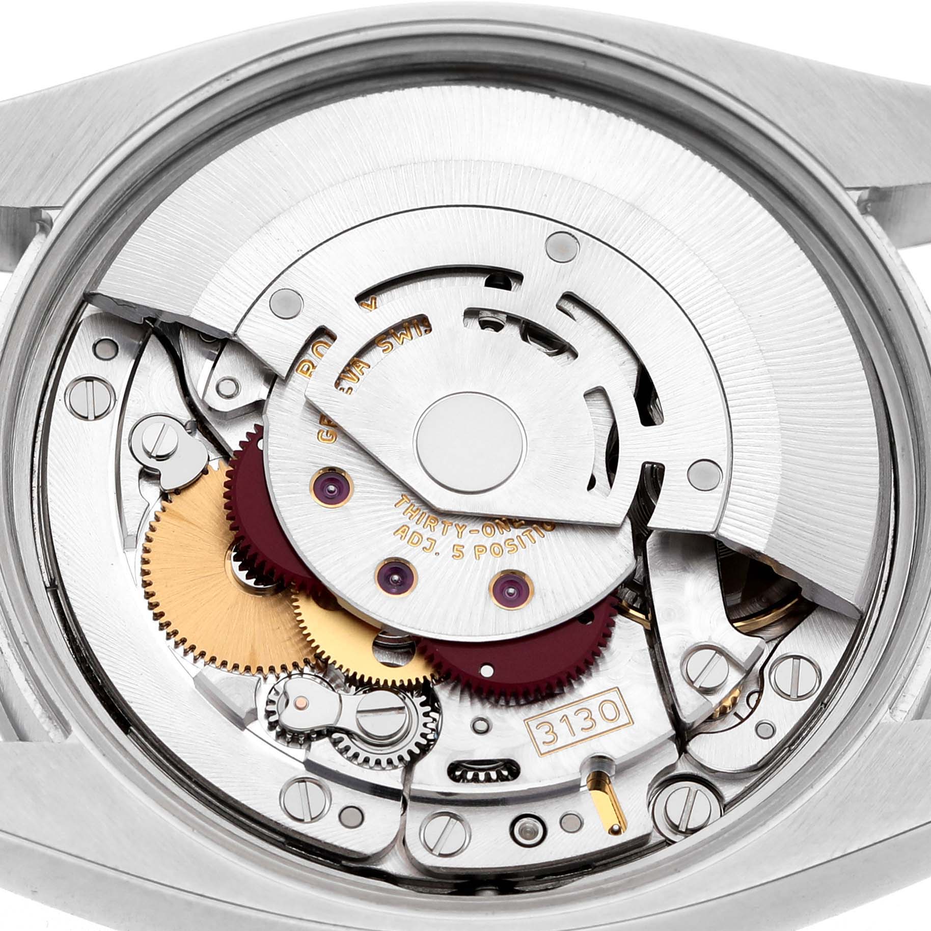 The image shows the movement of a Rolex Air-King 114200 Men's Stainless Steel Silver Dial watch viewed from the back, highlighting gears and mechanisms.