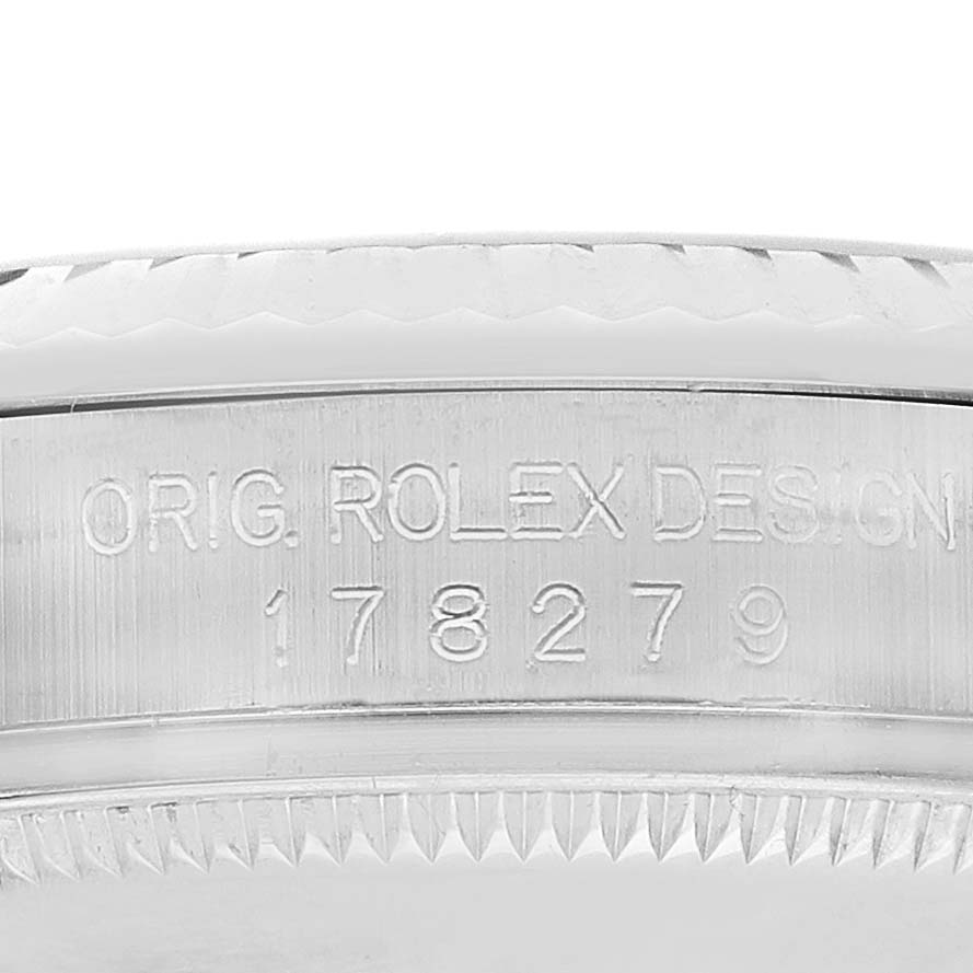 This image shows the side view of a Rolex President 178279 Women's White Gold Silver Dial model, focusing on the engraved serial number and design details.