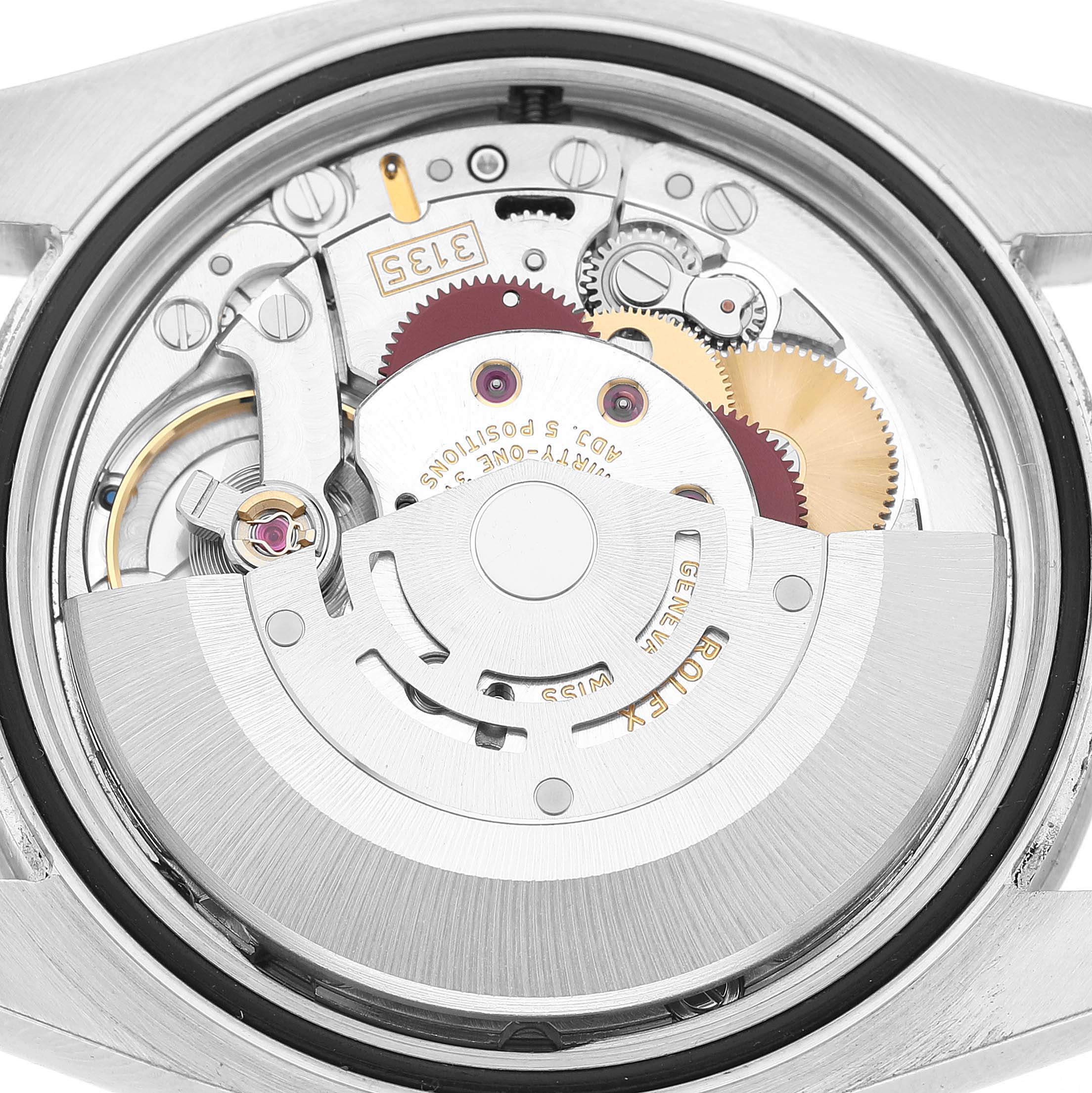 The image shows the movement of a Rolex Turn-o-Graph 116264 Men's Stainless Steel Black Dial watch from the back, highlighting gears and mechanisms.
