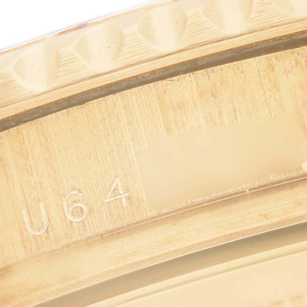 This close-up image shows the engraving and part of the bezel on a Rolex Yacht-Master M16628 Men's Yellow Gold White Dial M16628 Men's Yellow Gold White Dial watch.