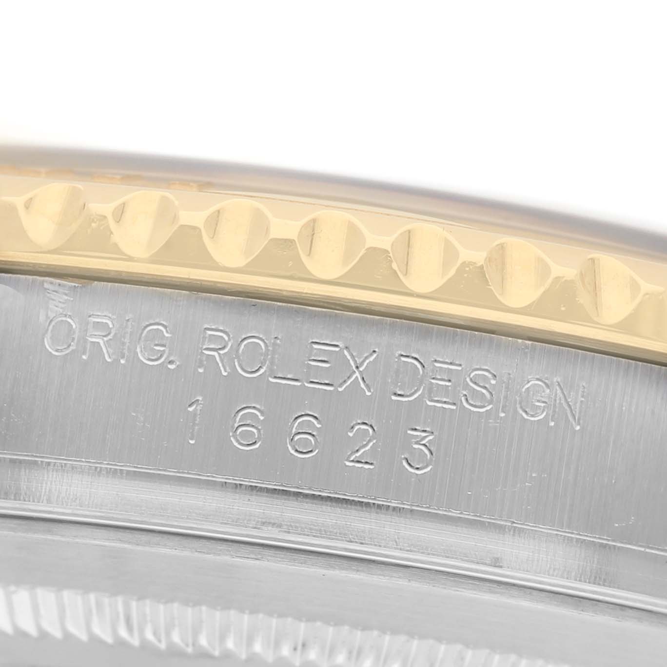 The image shows a close-up of the Rolex Yacht-Master 16623 Men's Steel and Gold (two tone) Champagne Dial's bezel and engraved side, highlighting the "ORIG. ROLEX DESIGN" and model number.