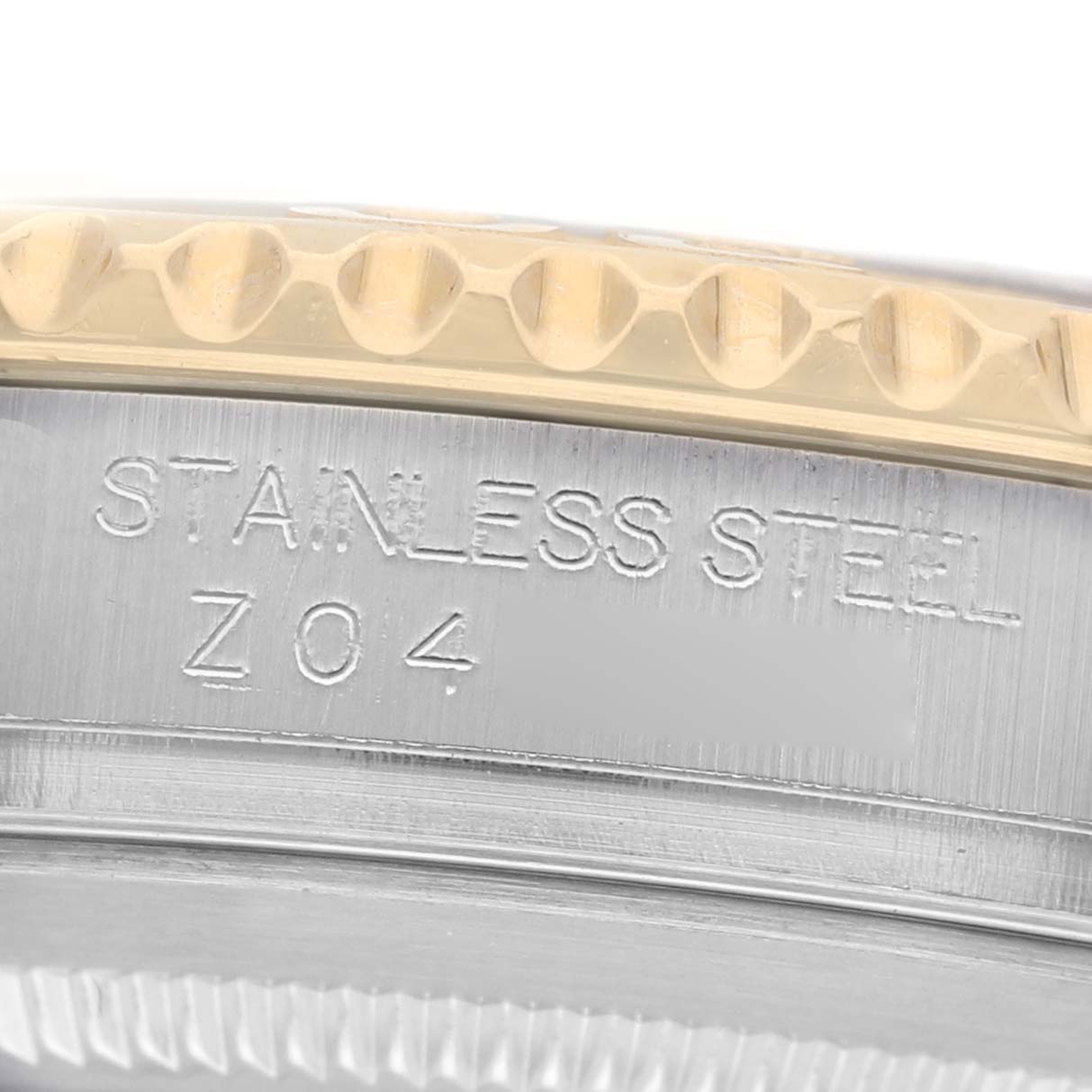 The image shows a close-up of the bezel and case side of a Rolex Yacht-Master 16623 Men's Steel and Gold (two tone) Champagne Dial watch, highlighting the engraving and edge detail.