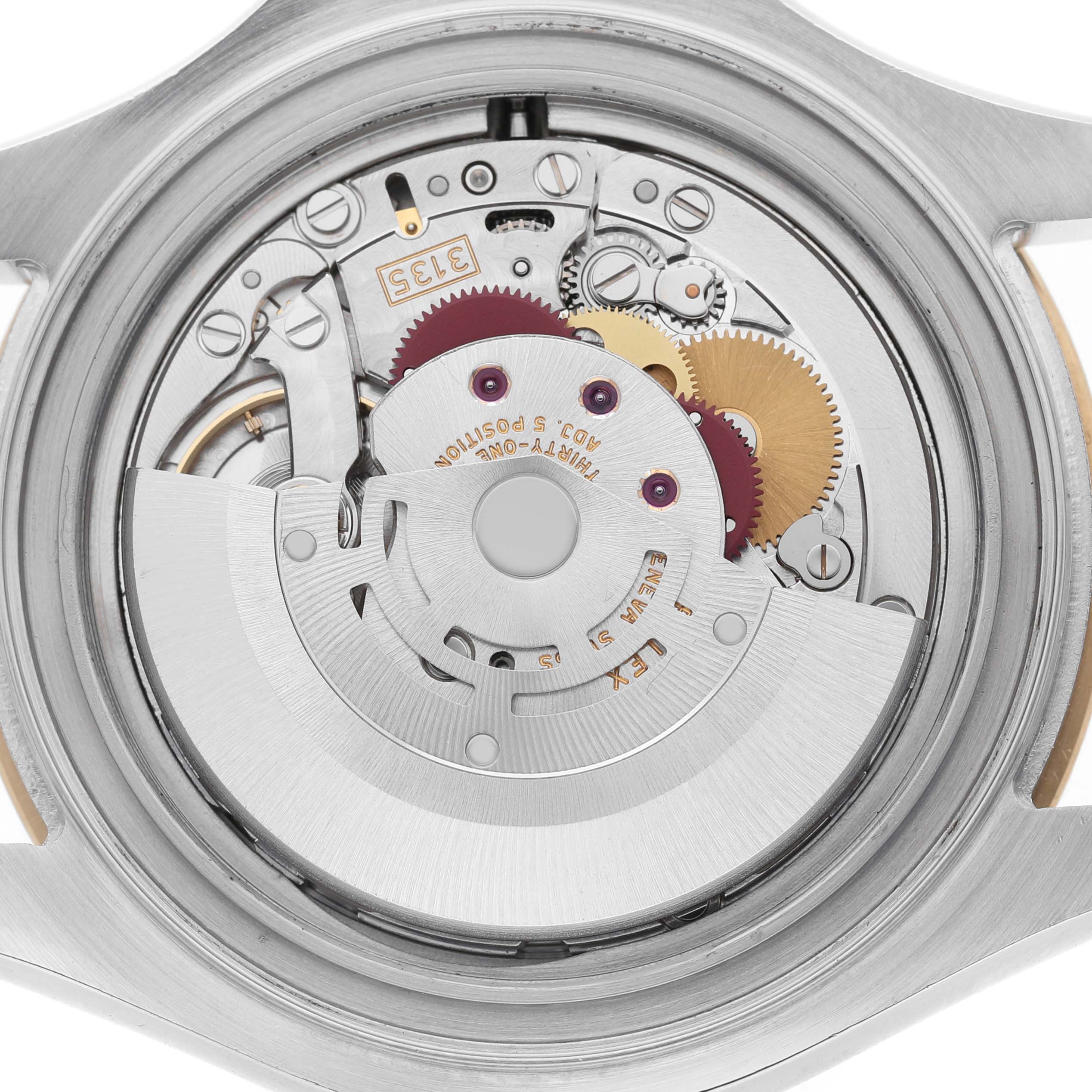 The image shows the movement from the back of a Rolex Yacht-Master 16623 Men's Steel and Gold (two tone) Champagne Dial, highlighting gears and mechanical parts.