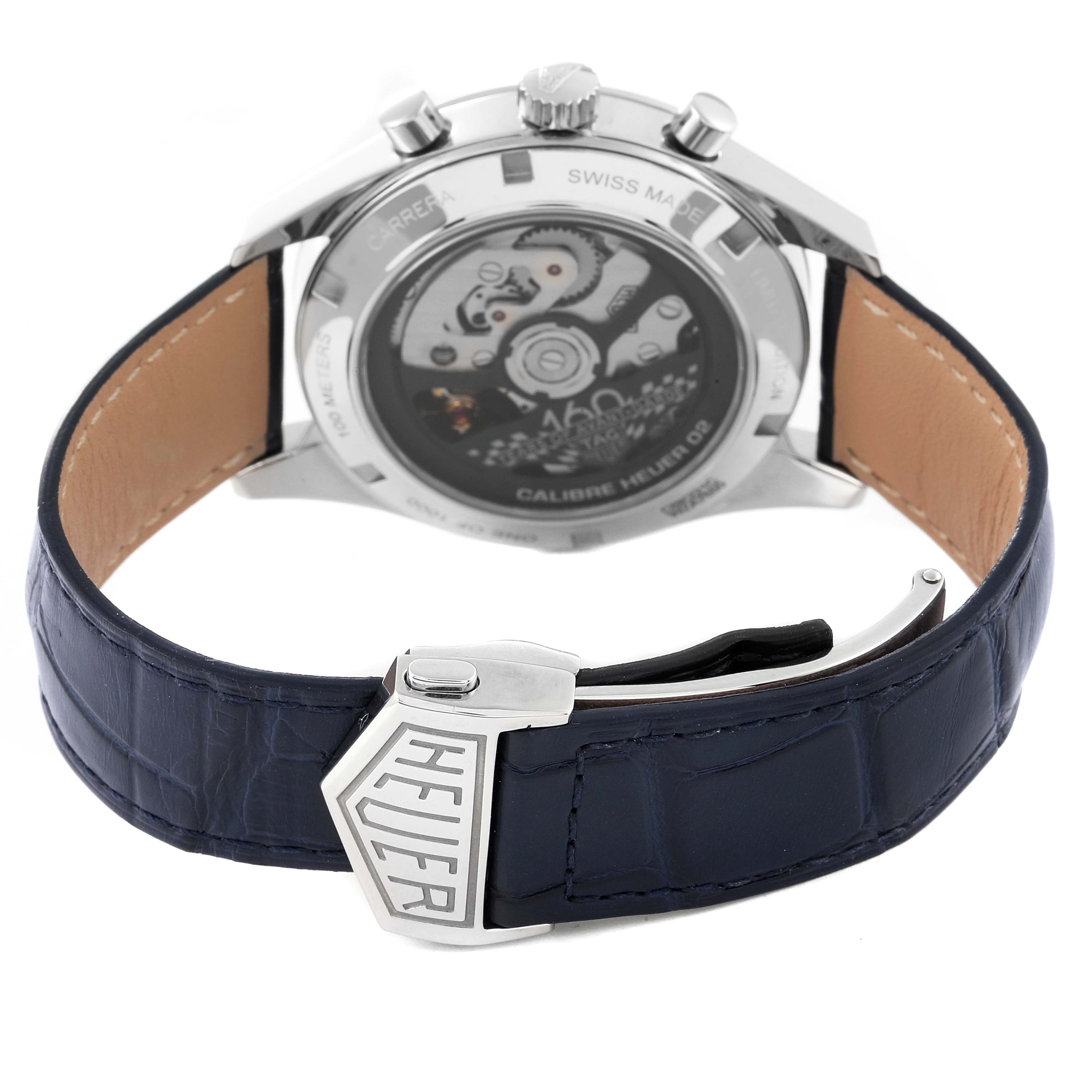 The image shows the back view of a Tag Heuer Carrera CBK221C.FC6488 Men's Stainless Steel White Dial CBK221C.FC6488 Men's Stainless Steel White Dial watch, highlighting the movement and the leather strap with the Heuer clasp.