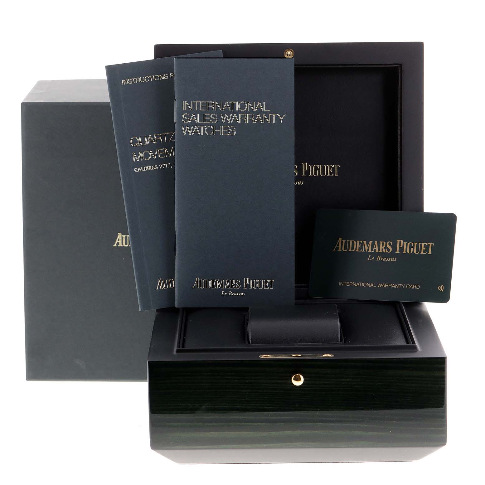 The image shows the packaging, manuals, and warranty card for the Royal Oak model by Audemars Piguet.