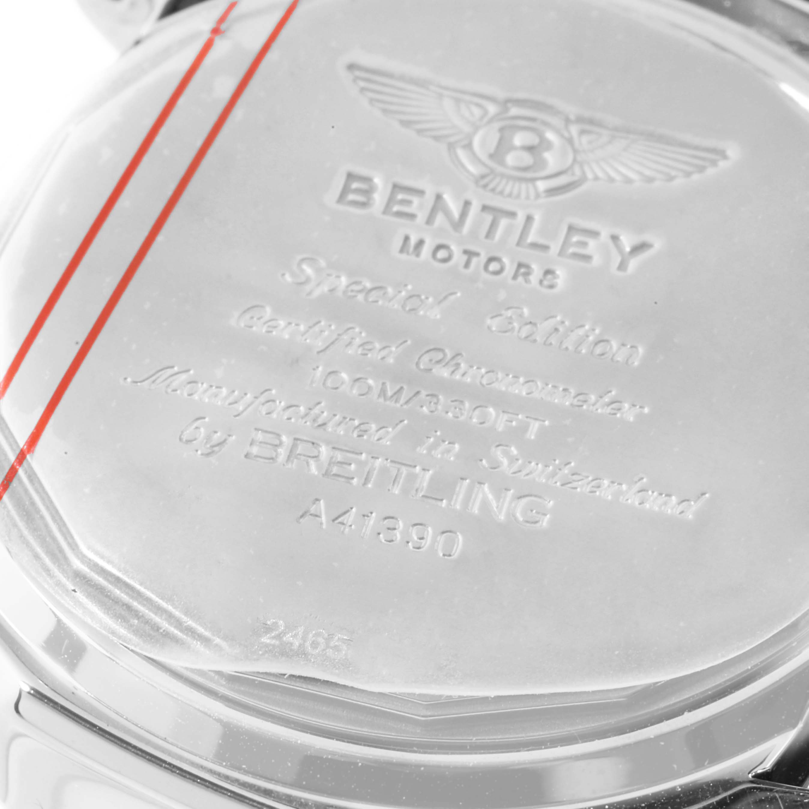 The image shows the back case of a Bentley model watch by Breitling, displaying engravings and branding.