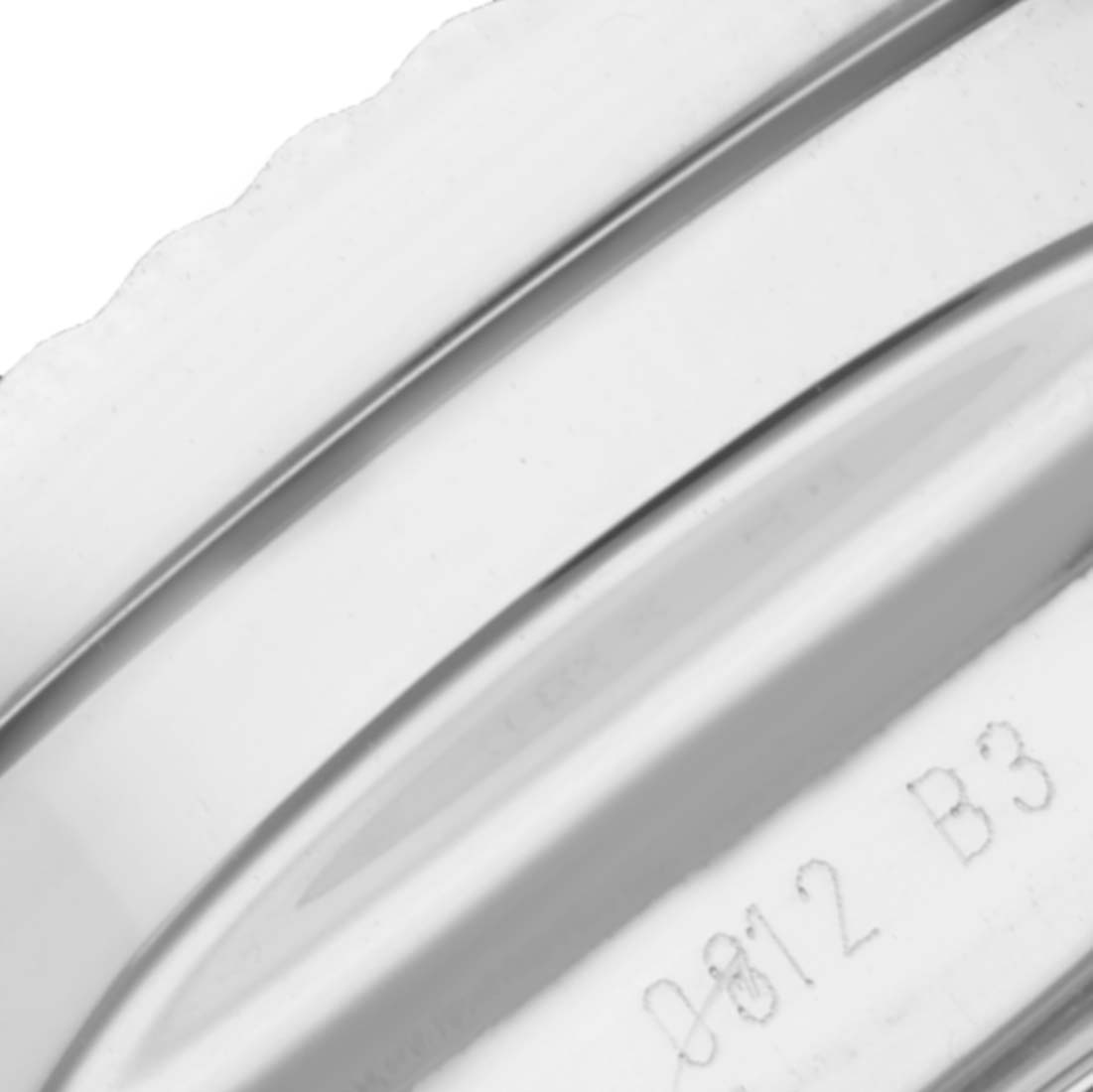 This close-up image shows a part of the bezel or caseback of a Breitling Bentley A25368B11SP Men's Stainless Steel Black Dial A25368B11SP Men's Stainless Steel Black Dial watch model, including an engraved serial number.