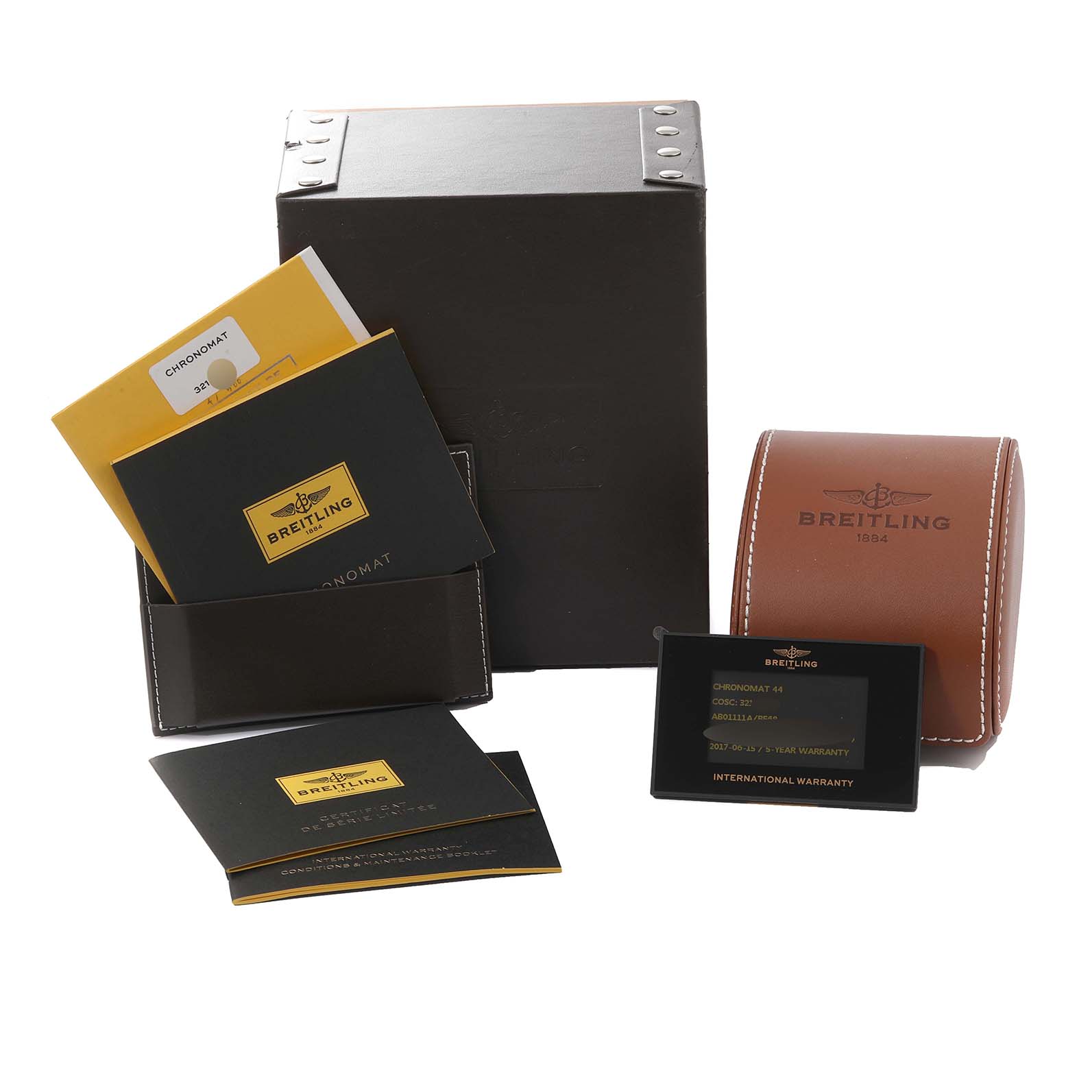 The image shows packaging and documentation for a Breitling Limited Series watch, including manuals, warranty cards, and a watch case.