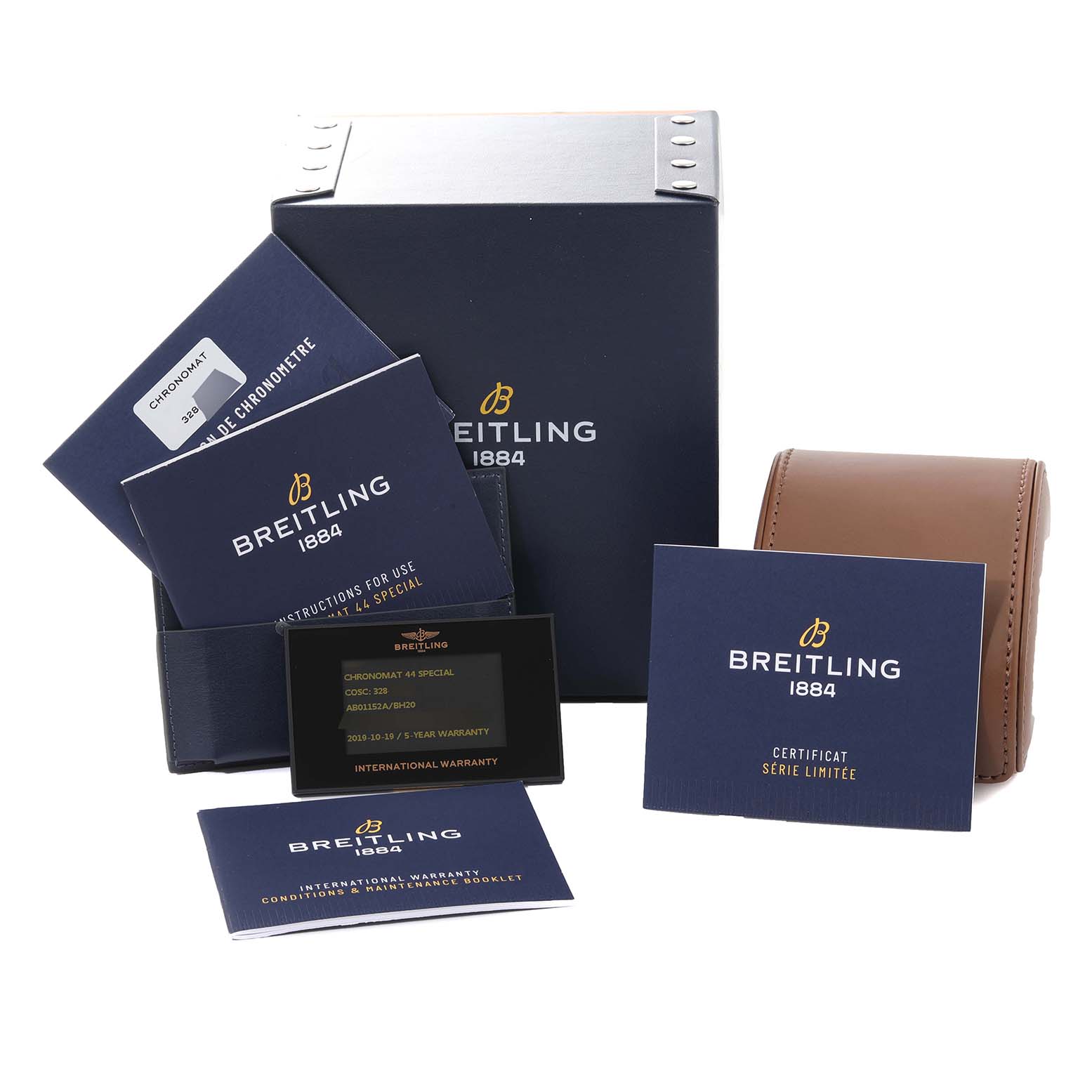 The image shows the packaging, warranty card, and documentation for the Breitling Limited Series Chronomat watch.
