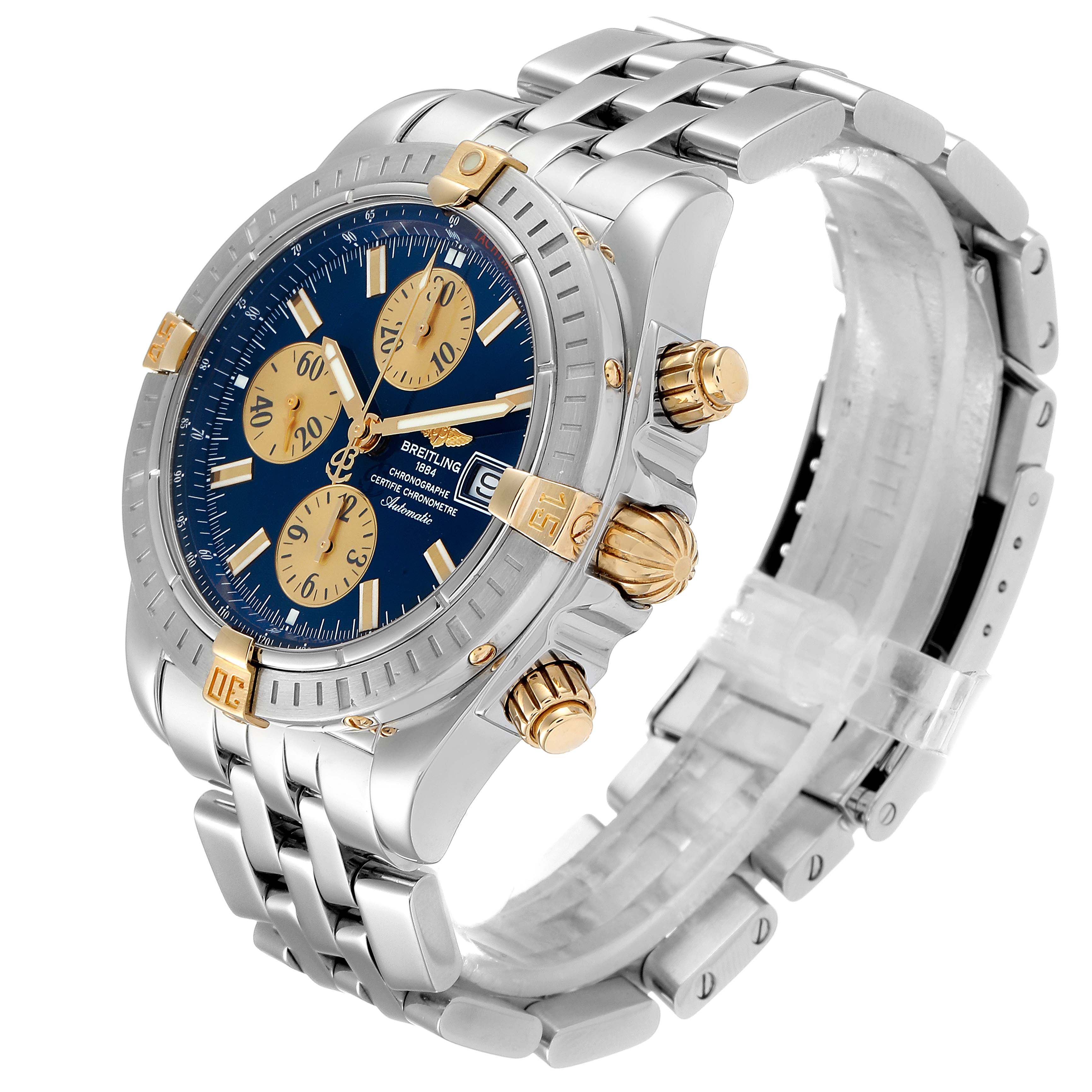 The image shows a Breitling Chronomat B13356 Men's Steel and Gold (two tone) Blue Dial B13356 Men's Steel and Gold (two tone) Blue Dial watch from an angled side view, highlighting its face, bezel, crown, and bracelet.