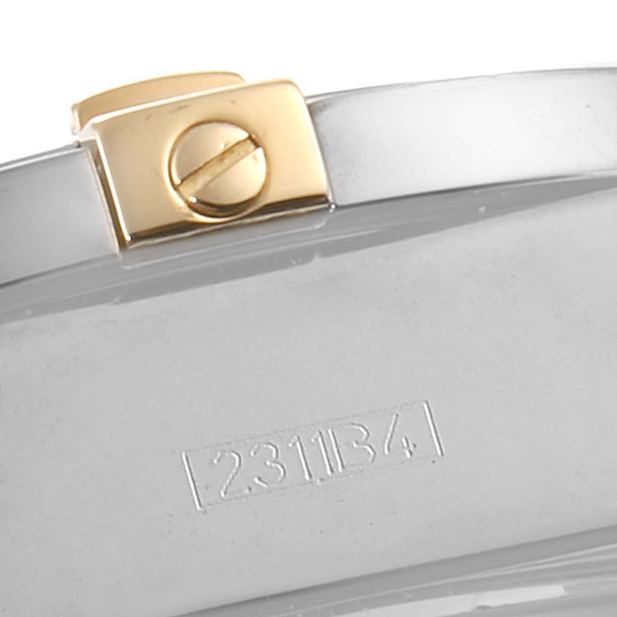 This image shows a close-up of the back of a Breitling Chronomat B13356 Men's Steel and Gold (two tone) Blue Dial B13356 Men's Steel and Gold (two tone) Blue Dial watch, focusing on its screw and part of its serial number.