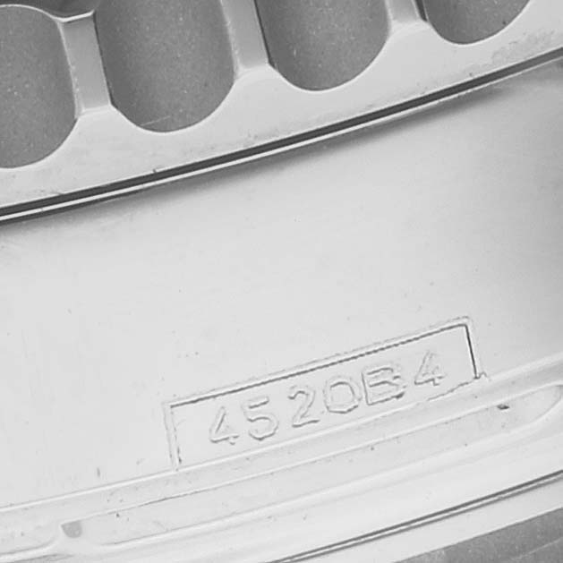 The image shows a close-up of the engraved serial number on the back case of a Breitling Navitimer AB0121 Men
s Stainless Steel Mother of Pearl Dial AB0121 Men
s Stainless Steel Mother of Pearl Dial watch.