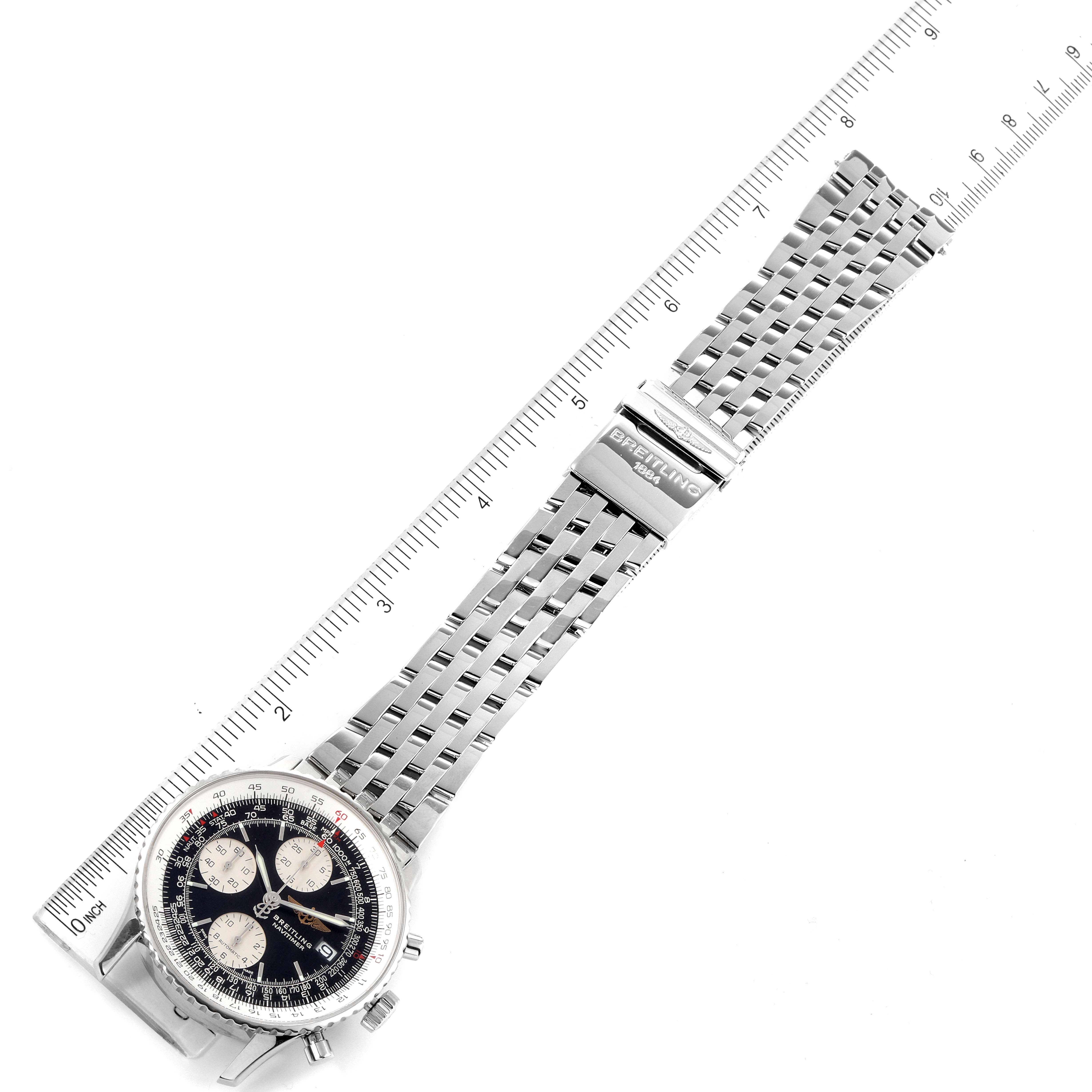 The image shows a Breitling Navitimer A13324 Men's Stainless Steel Black Dial A13324 Men's Stainless Steel Black Dial watch laid flat, highlighting its stainless steel bracelet and clasp against a ruler.
