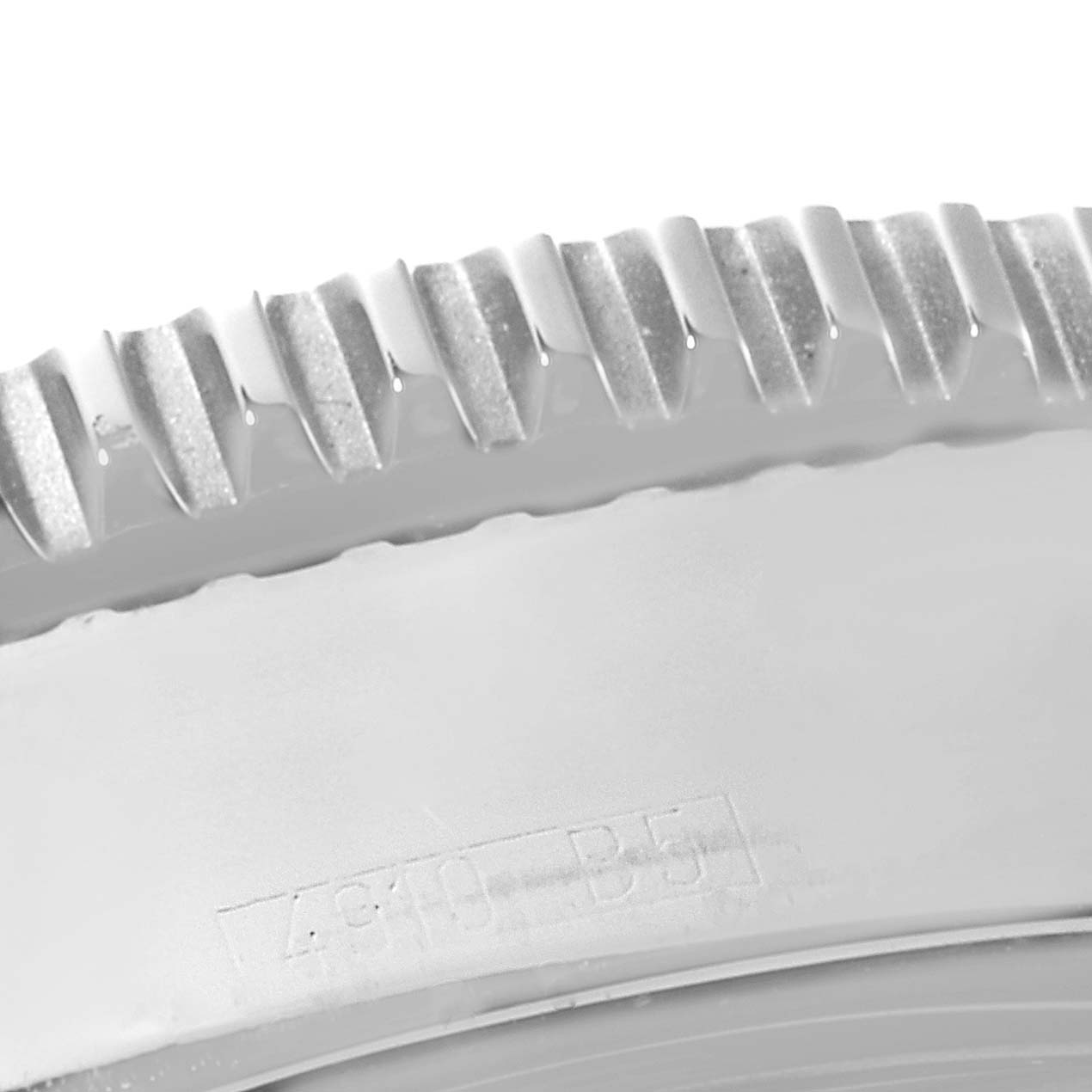 This close-up image shows the serrated edge of the bezel and part of the case back of the Breitling Superocean A17364 Men's Stainless Steel Black Dial A17364 Men's Stainless Steel Black Dial watch.