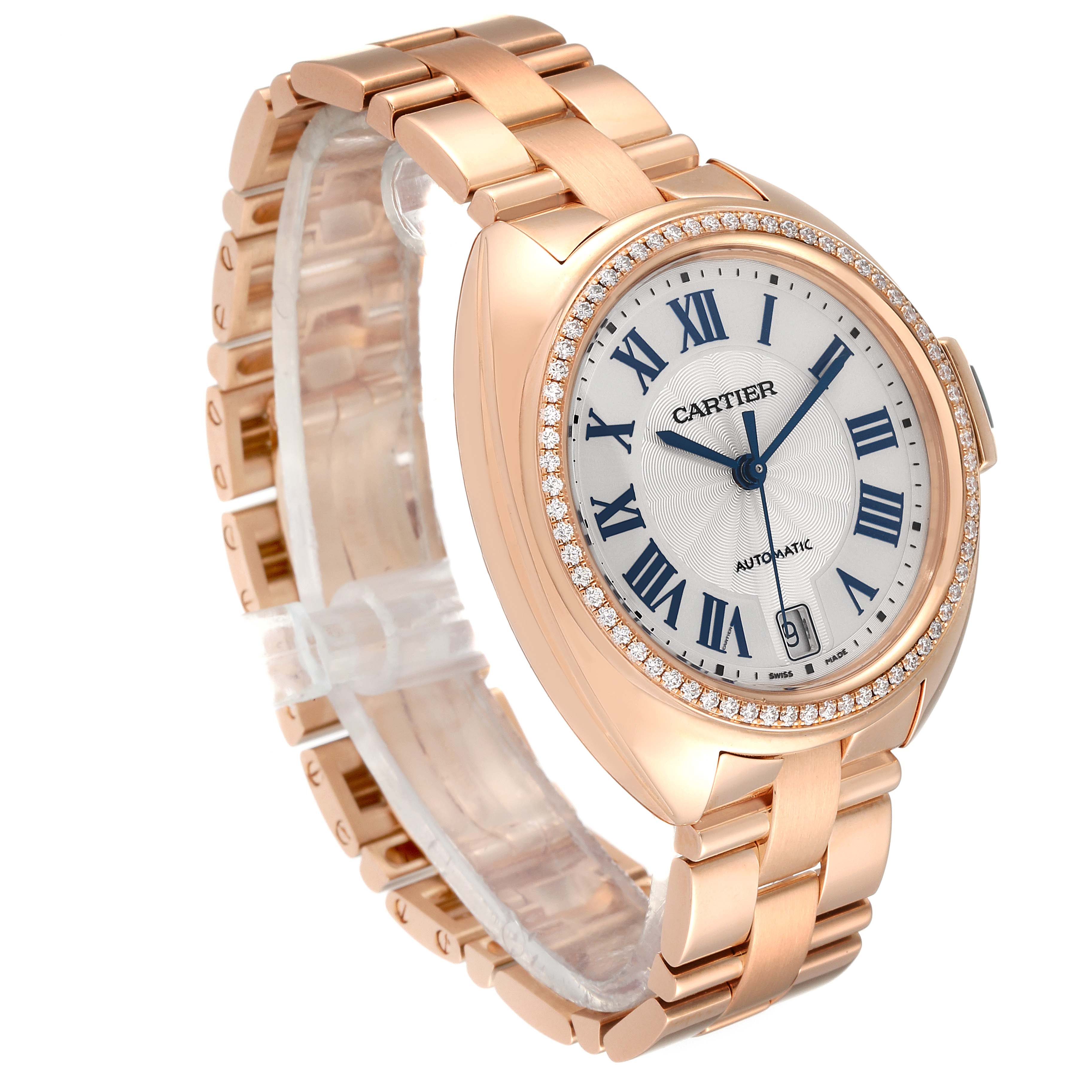 The image shows a Cartier Cle WFCL0003 Women's Rose Gold Silver Dial WFCL0003 Women's Rose Gold Silver Dial model watch at a three-quarter angle, displaying its rose gold bracelet, diamond bezel, and white dial with Roman numerals.