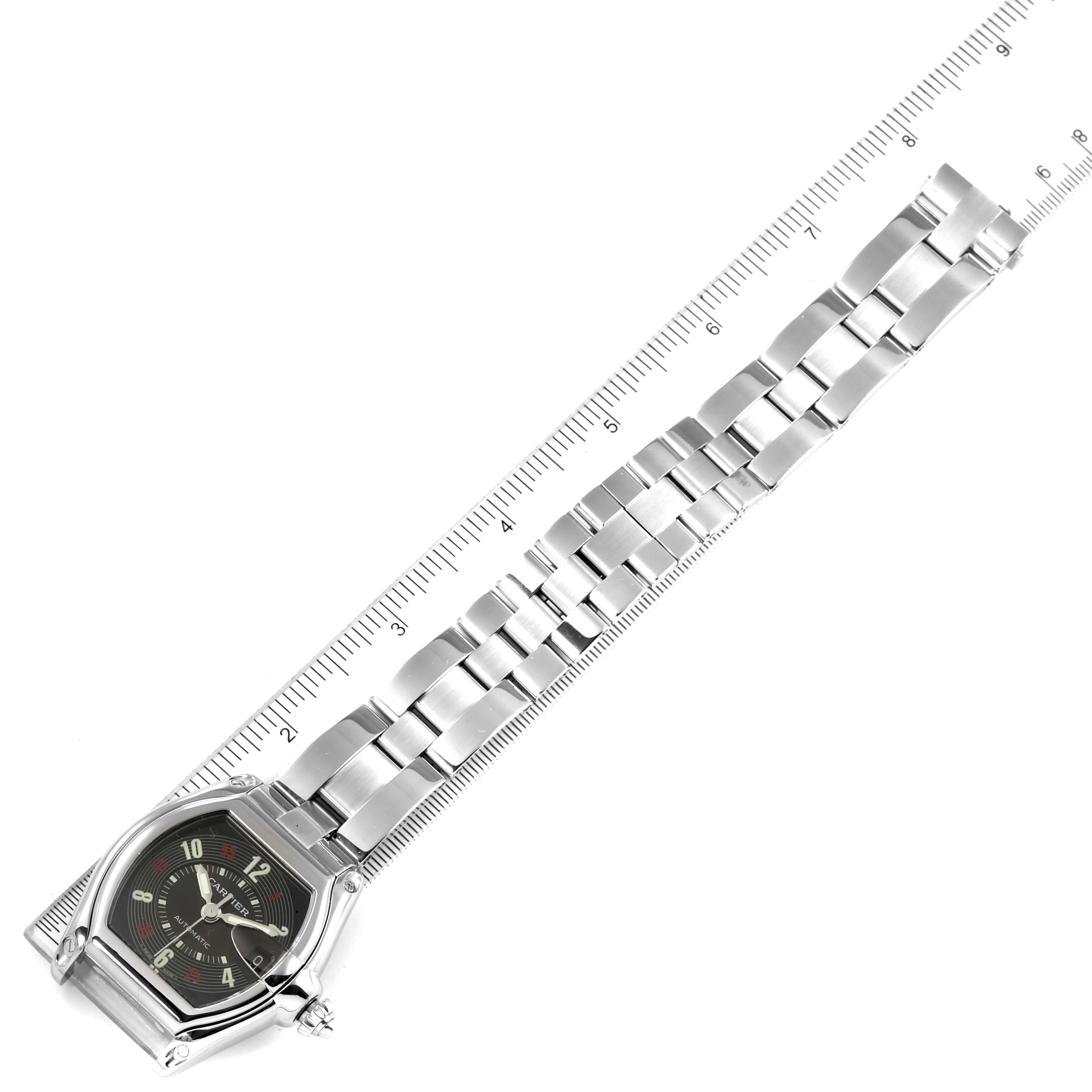 The Cartier Roadster W62002V3 Men
s Stainless Steel Black Dial W62002V3 Men
s Stainless Steel Black Dial model watch is shown from a top-down angle alongside a ruler.
