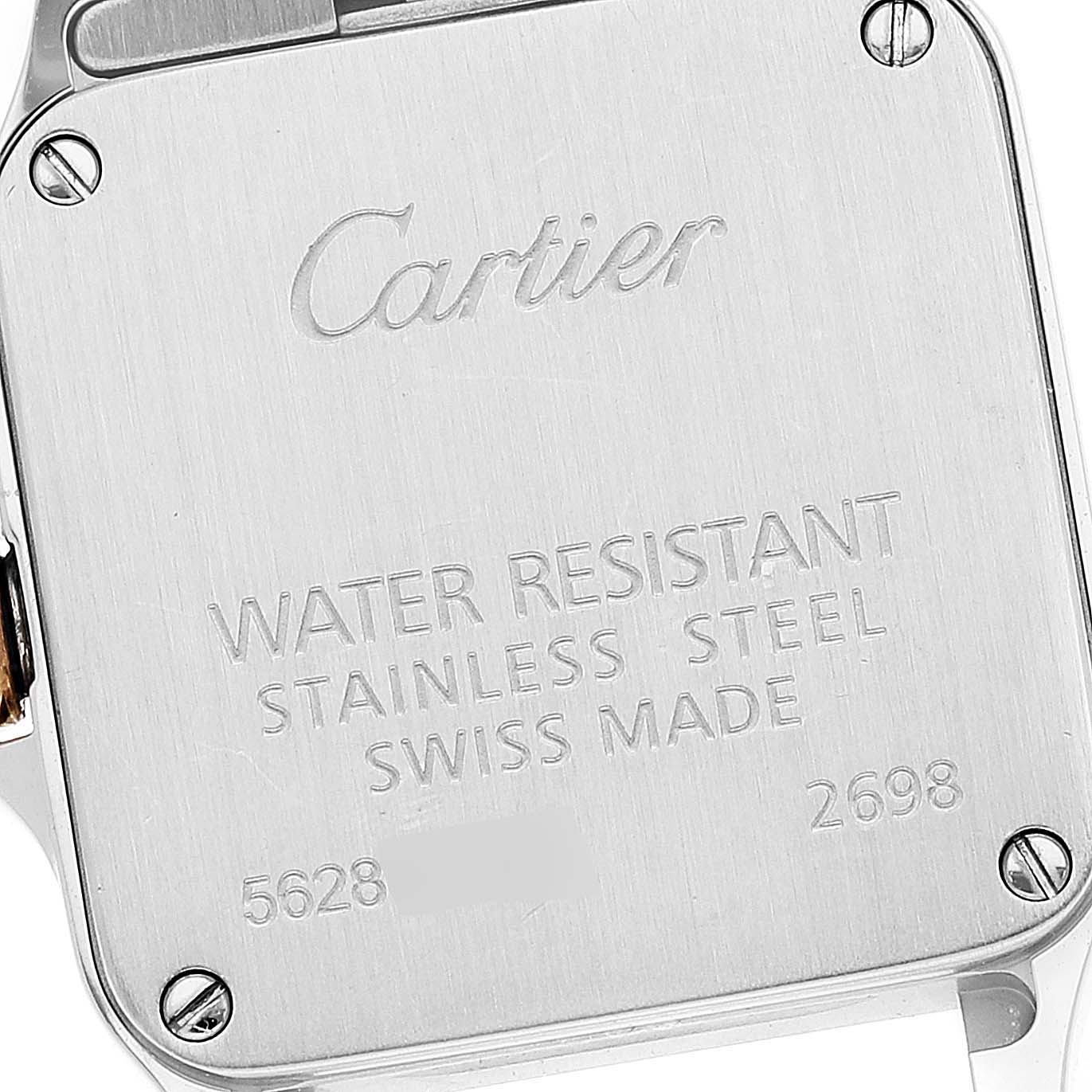 The image shows the back casing of a Santos Demoiselle watch by Cartier, highlighting the engraved brand name and specifications.