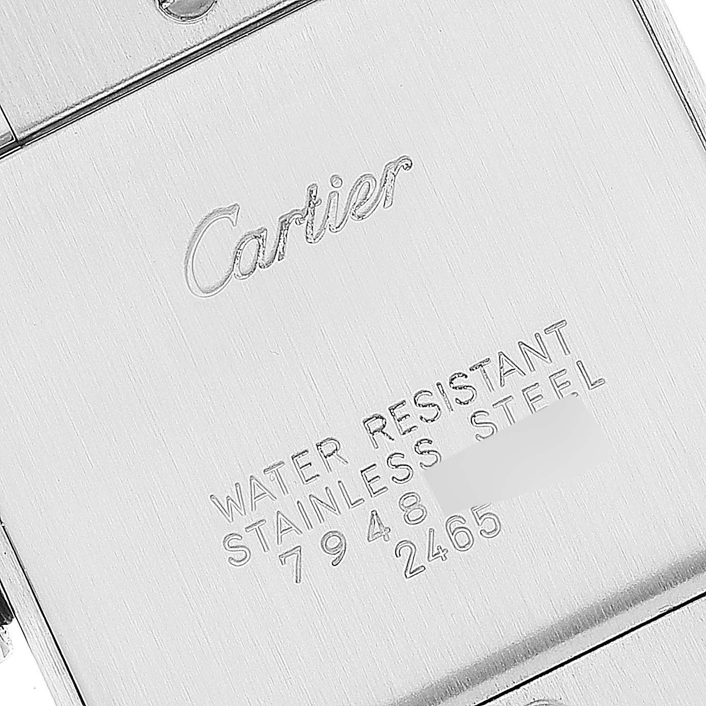 The image shows the back of a Tank Française model by Cartier, displaying engravings that indicate the brand and specifications.
