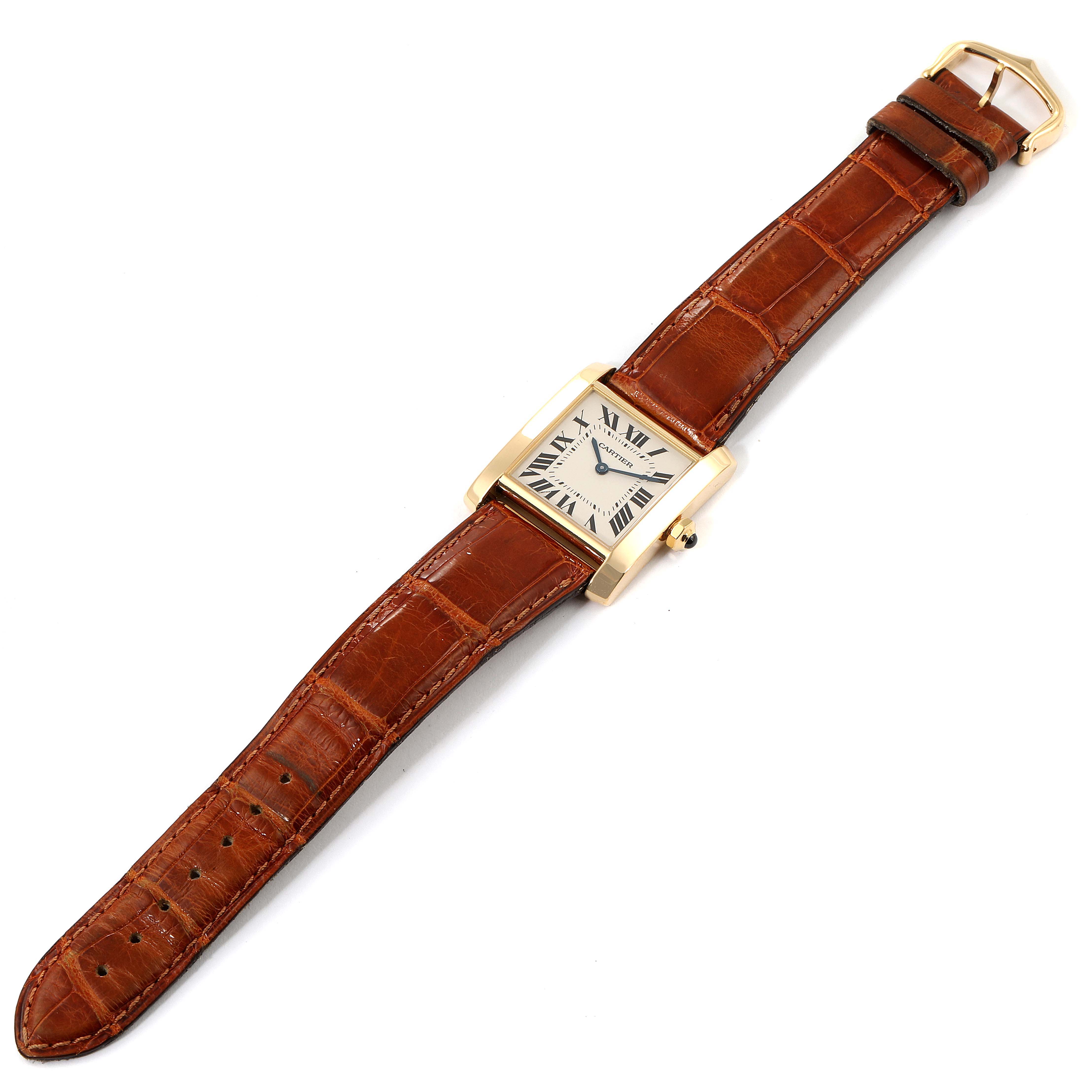The image shows a full view of a Cartier Tank Française watch with a rectangular dial and a brown leather strap.