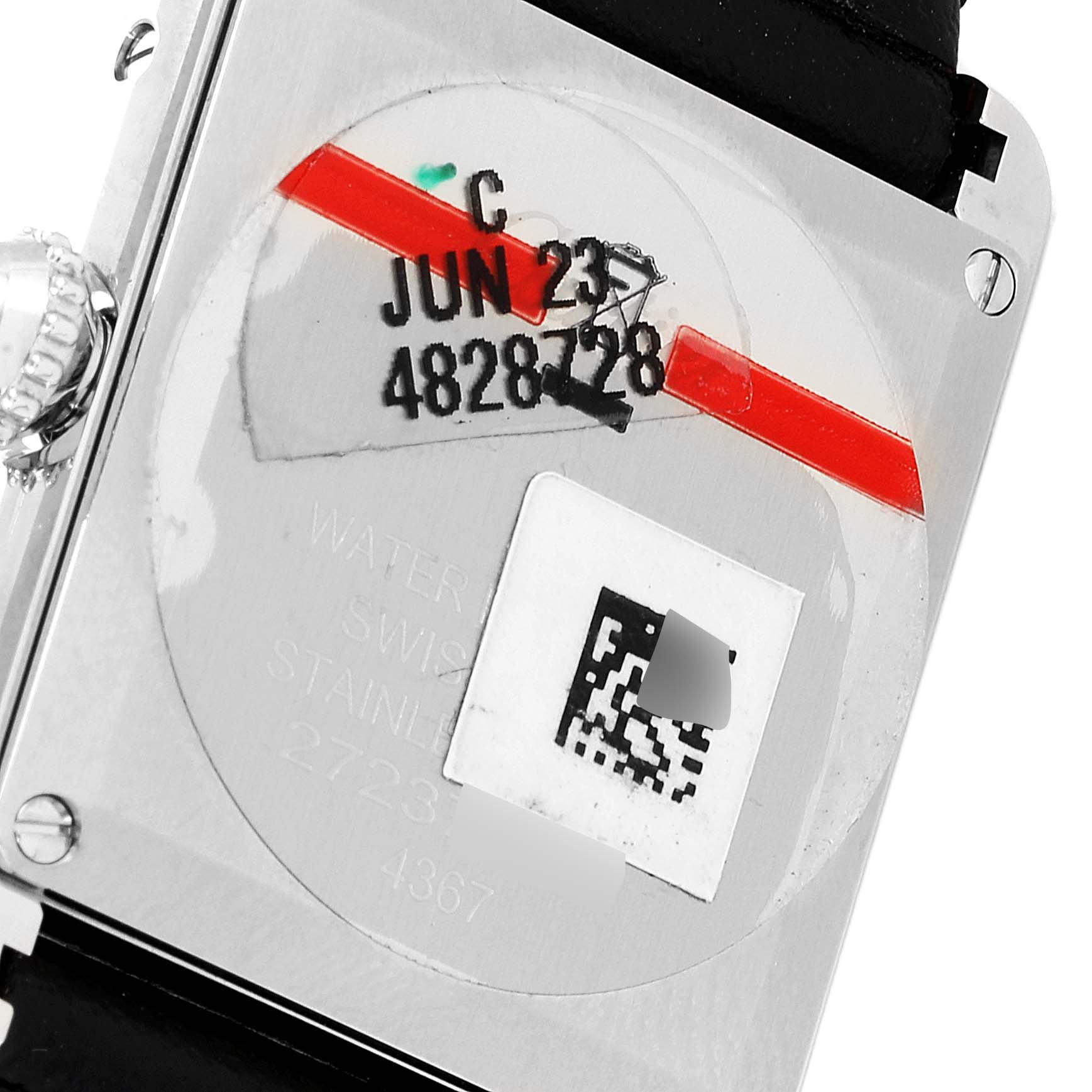 This image shows the back of a Cartier Tank Must WSTA0060 Women's Stainless Steel Silver Dial WSTA0060 Women's Stainless Steel Silver Dial watch, displaying the serial number, a barcode, and date stamps.