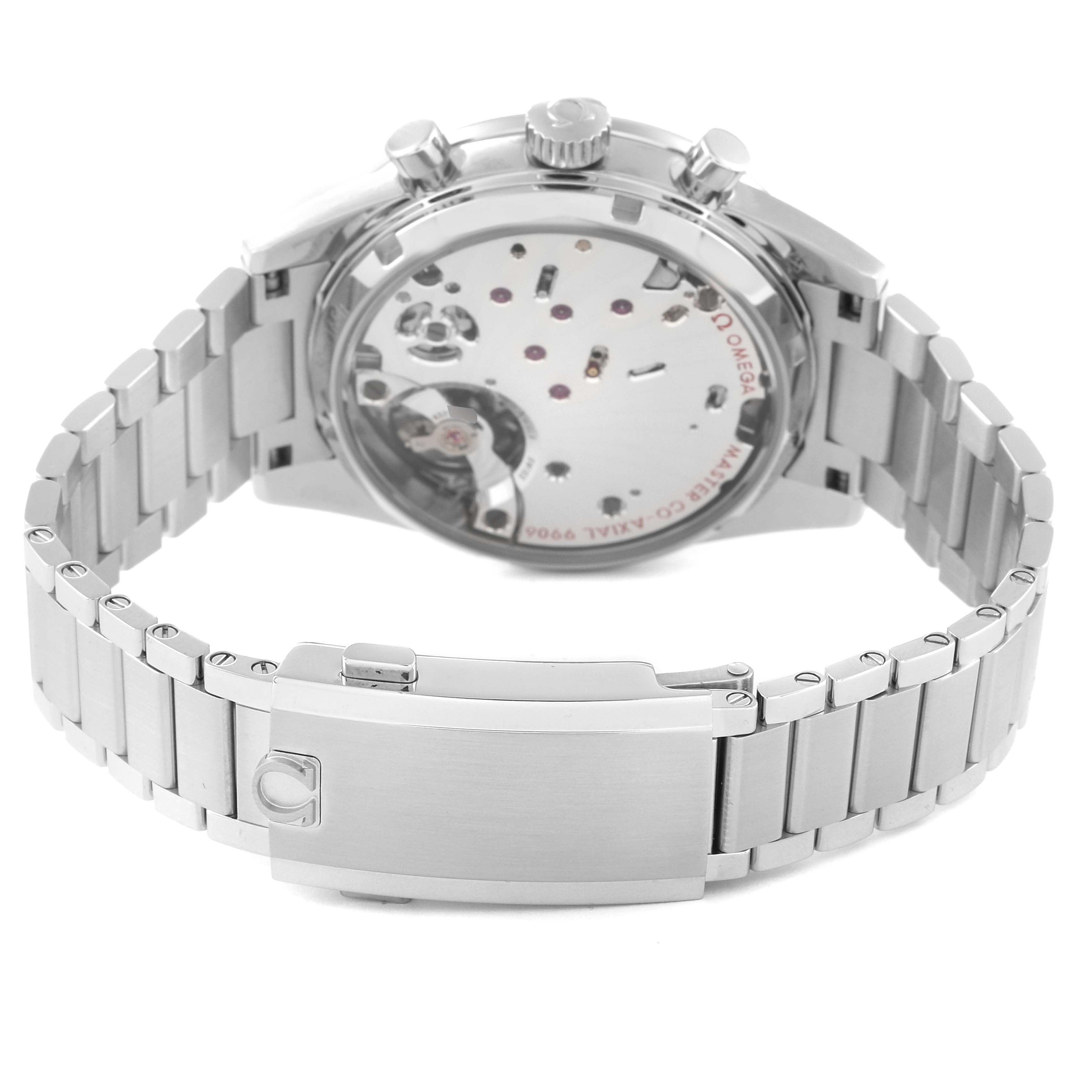 The image shows the Omega Speedmaster 332.10.41.51.11.001 Men's Stainless Steel Red Dial watch from the back, highlighting its movement and stainless steel bracelet.