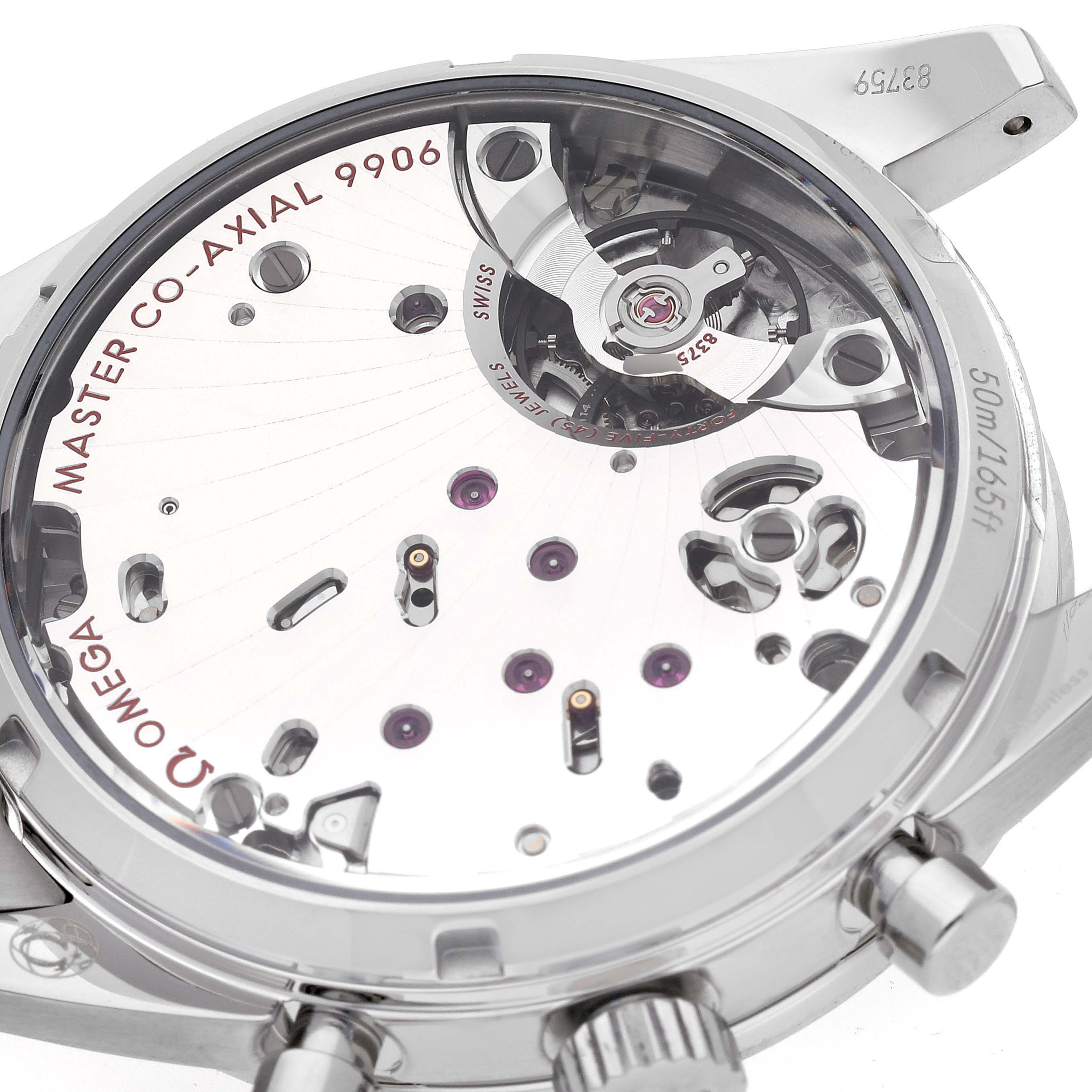 The image shows the back of an Omega Speedmaster 332.10.41.51.11.001 Men's Stainless Steel Red Dial, highlighting the Master Co-Axial 9906 movement components.