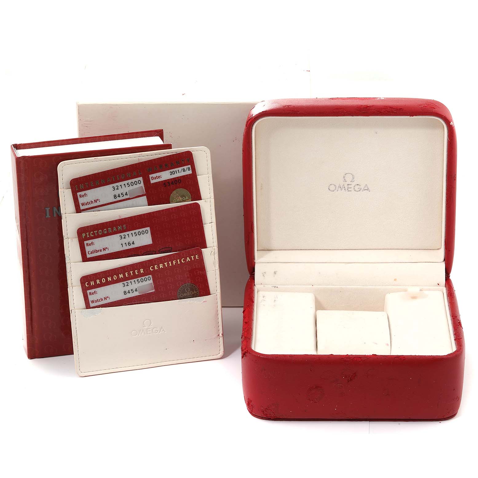 The image shows a red Omega Speedmaster 3511.50.00 Men
s Stainless Steel Black Dial 3511.50.00 Men
s Stainless Steel Black Dial presentation box, instruction booklet, and warranty cards viewed from a front angle.