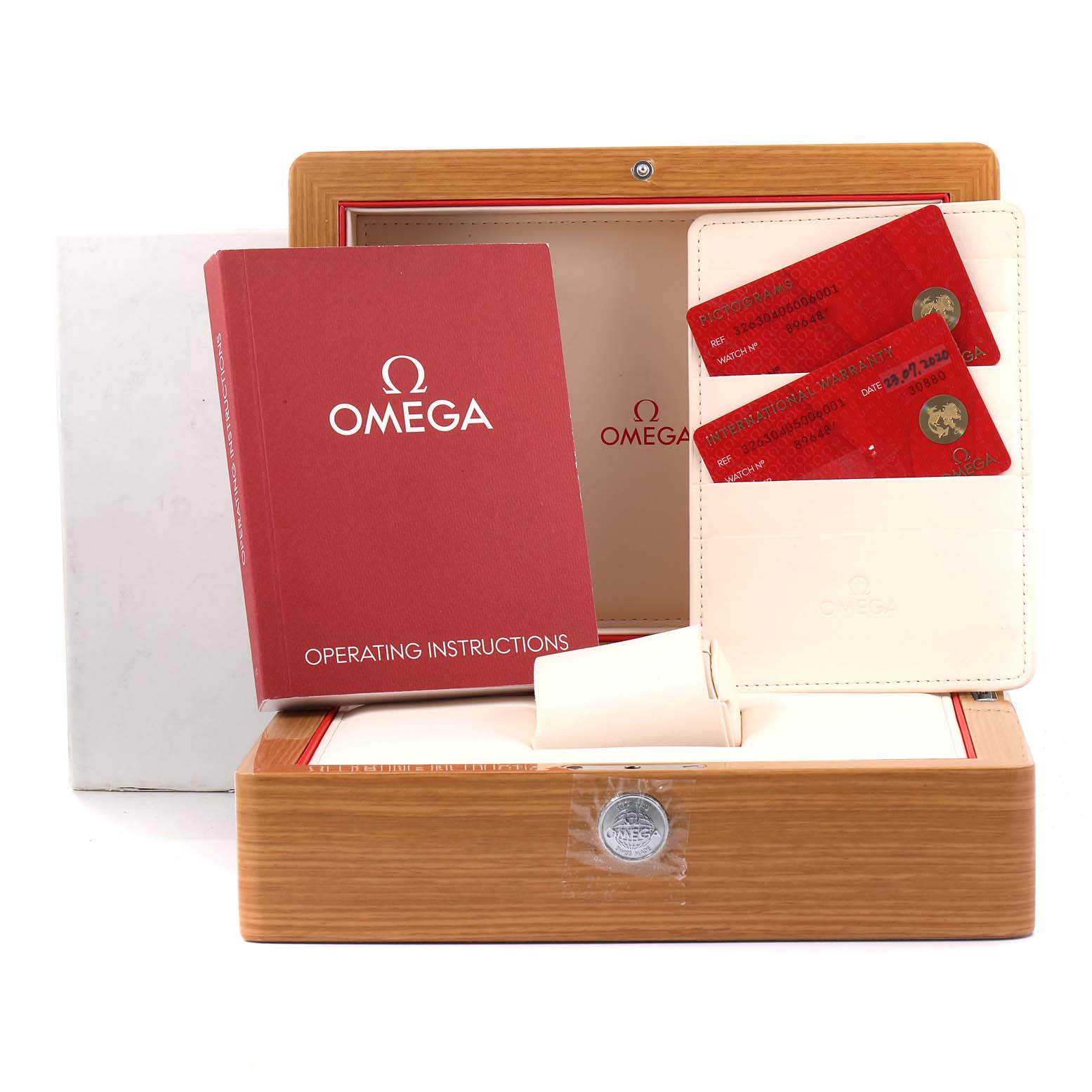 The image shows an Omega Speedmaster 326.30.40.50.06.001 Men's Stainless Steel Grey Dial 326.30.40.50.06.001 Men's Stainless Steel Grey Dial watch box with operating instructions, warranty cards, and a cardholder.