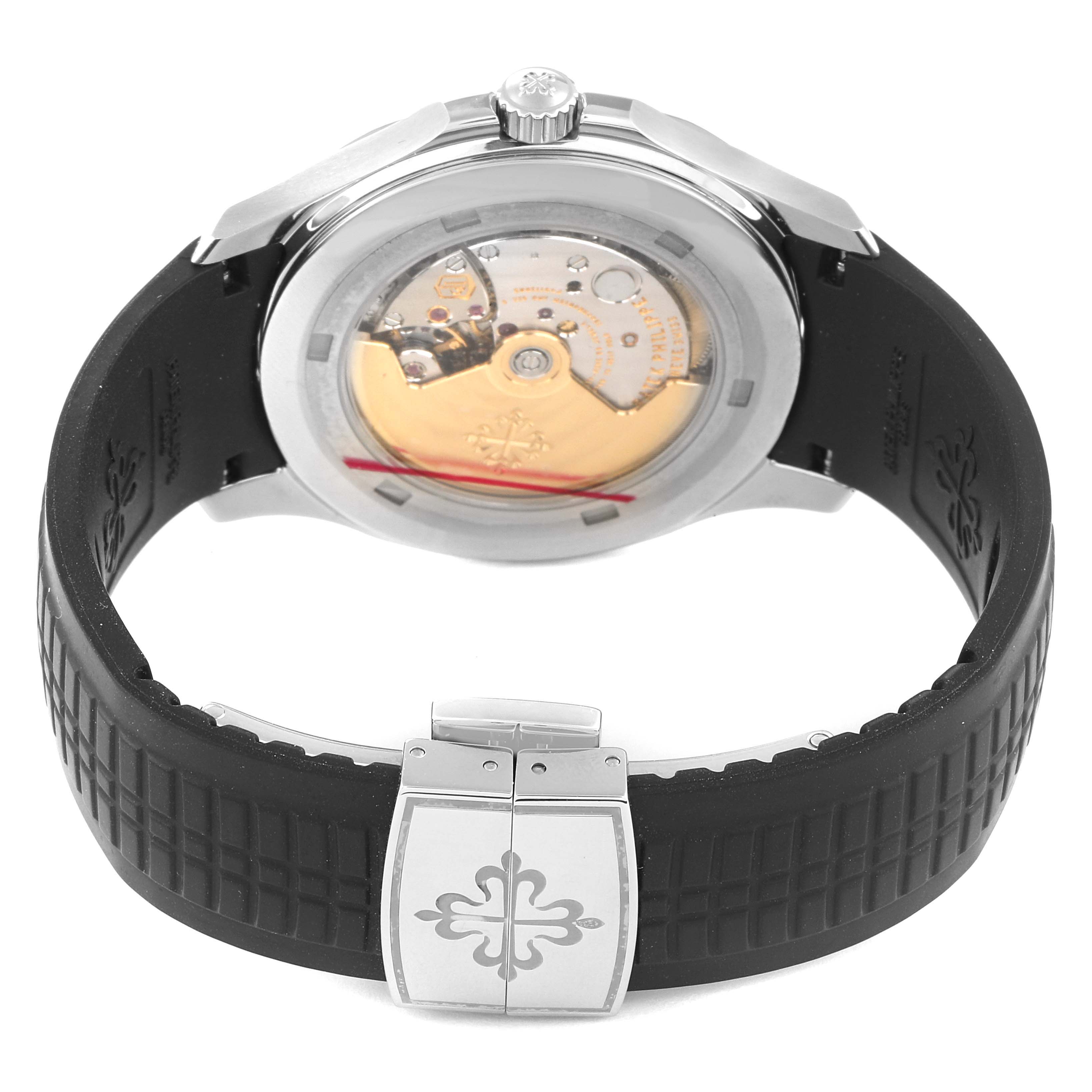 The image shows the back view of a Patek Philippe Aquanaut 5167A Men's Stainless Steel Black Dial 5167A Men's Stainless Steel Black Dial watch, highlighting its movement and the rubber strap with a clasp.