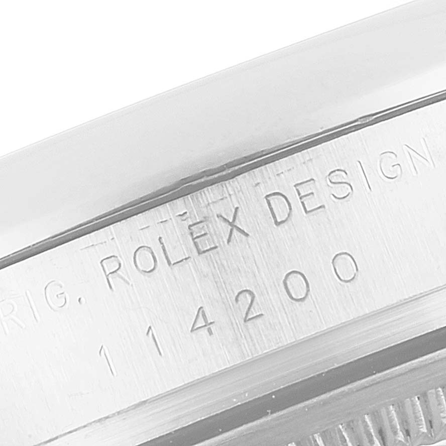 This image shows a close-up of the engraved model number on the case of a Rolex Air-King 114200 Men's Stainless Steel Silver Dial 114200 Men's Stainless Steel Silver Dial watch.
