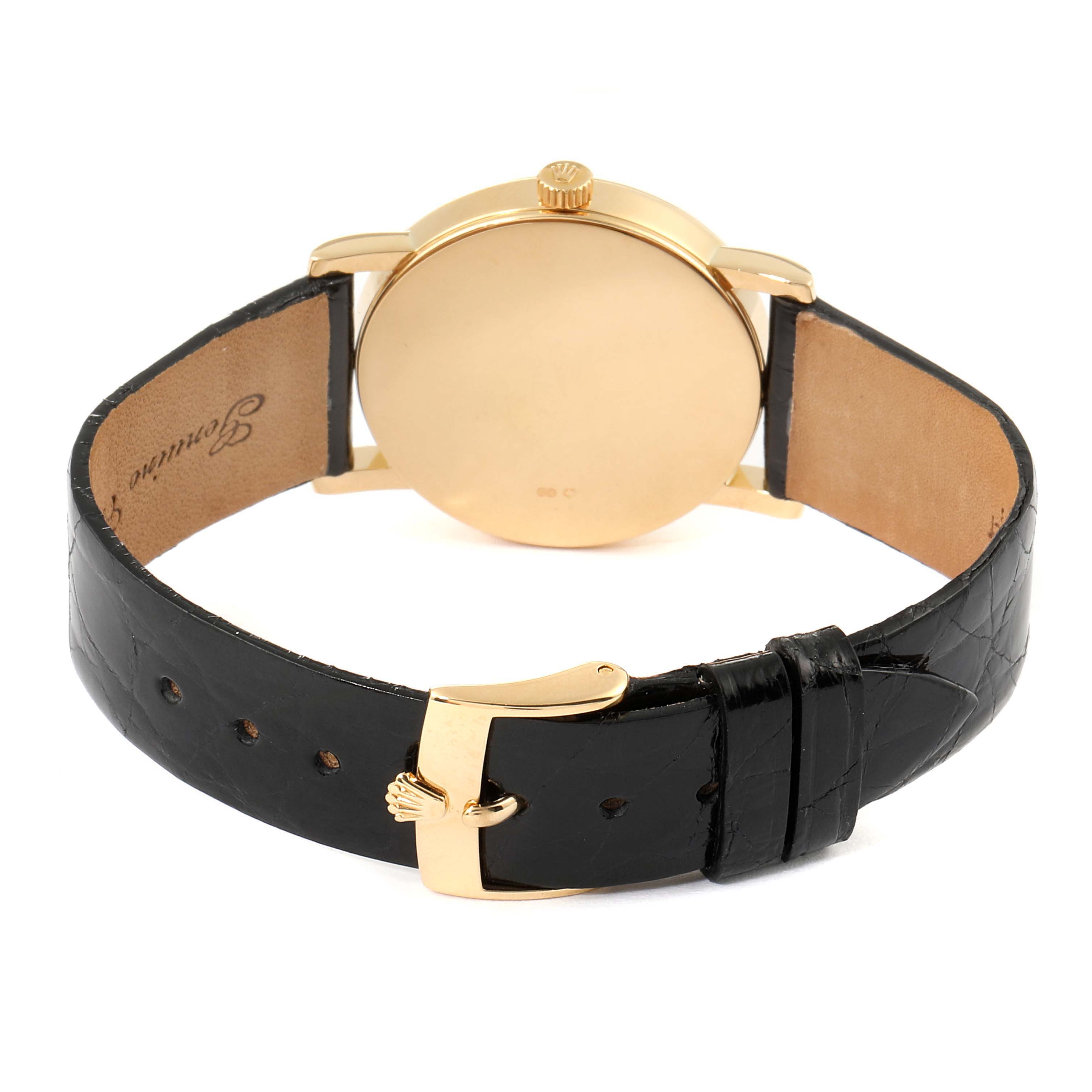 The image shows the back view of a Rolex Cellini 5115 Men's Yellow Gold Black Dial 5115 Men's Yellow Gold Black Dial watch, highlighting its gold case and black leather strap with a gold buckle.