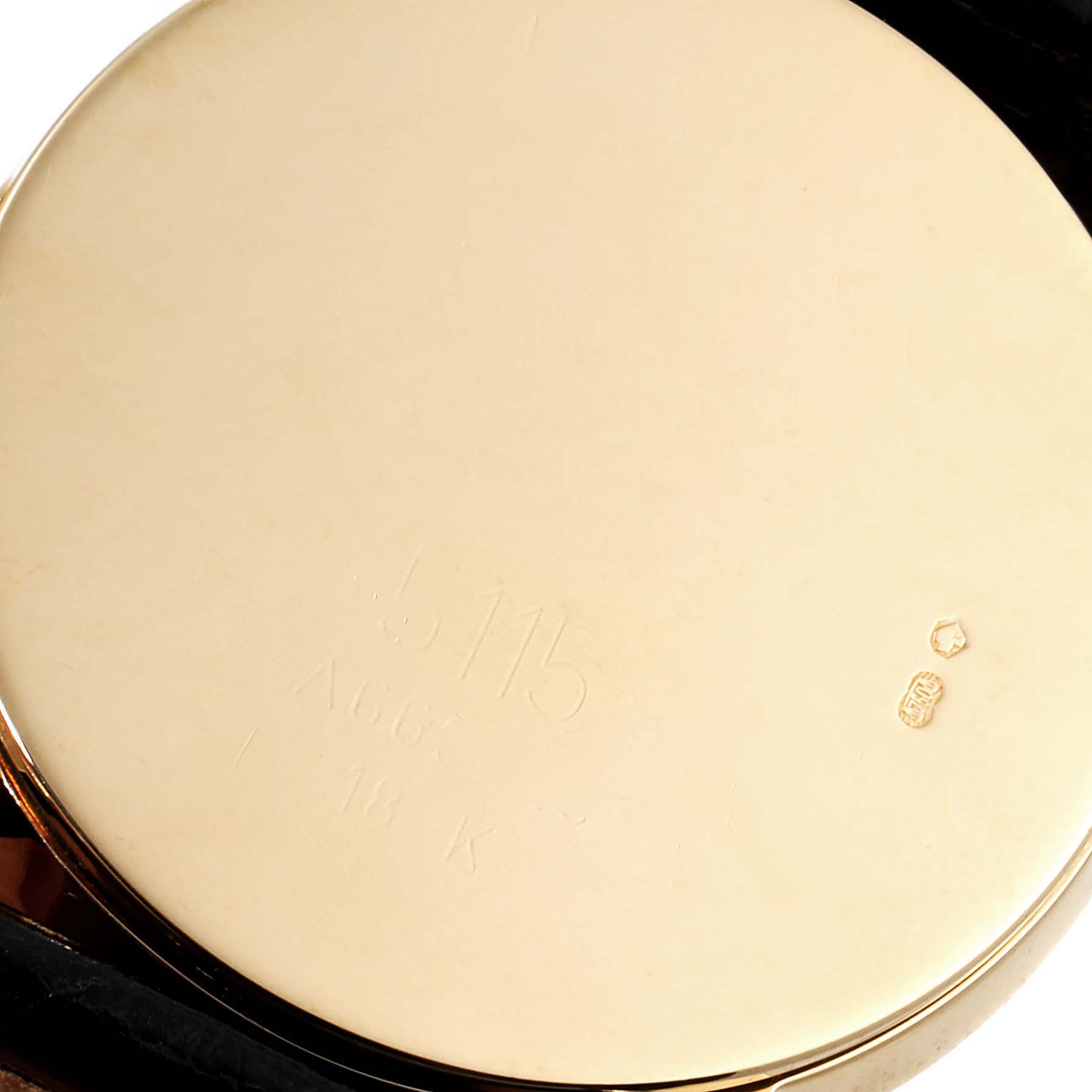 This image shows the back case of a Rolex Cellini 5115 Men's Yellow Gold Black Dial 5115 Men's Yellow Gold Black Dial watch, with inscriptions and hallmarks visible.