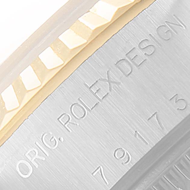 The image shows a close-up of the side casing and bezel of the Rolex Datejust 79173 Women
s Steel and Gold (two tone) Grey Dial 79173 Women
s Steel and Gold (two tone) Grey Dial watch, highlighting the "ORIG. ROLEX DESIGN" engraving.