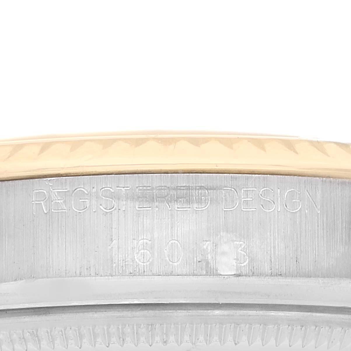 This is a close-up of the case side of the Rolex Vintage Collection 16013 Men's Steel and Gold (two tone) Black Dial 16013 Men's Steel and Gold (two tone) Black Dial watch showing the model number and "REGISTERED DESIGN" engraving.