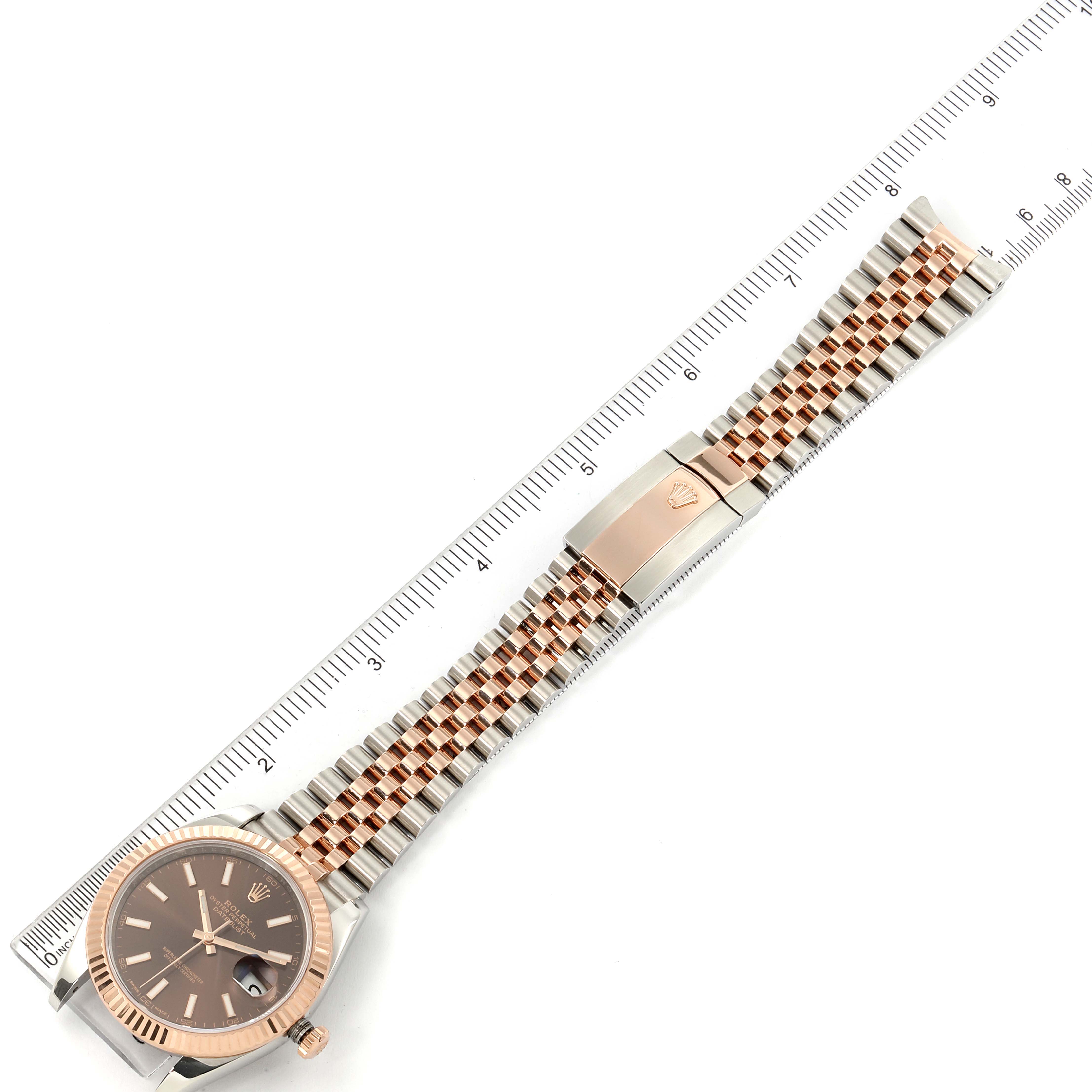 The Rolex Datejust 41 126331 Men
s Rose Gold Brown Dial 126331 Men
s Rose Gold Brown Dial is shown flat from above, displaying the dial, bracelet, and clasp, alongside a ruler for measurement.