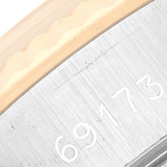 The image shows a close-up of the engraved case and bezel of a Rolex Datejust 69173G Women's Stainless Steel Champagne Dial 69173G Women's Stainless Steel Champagne Dial watch.