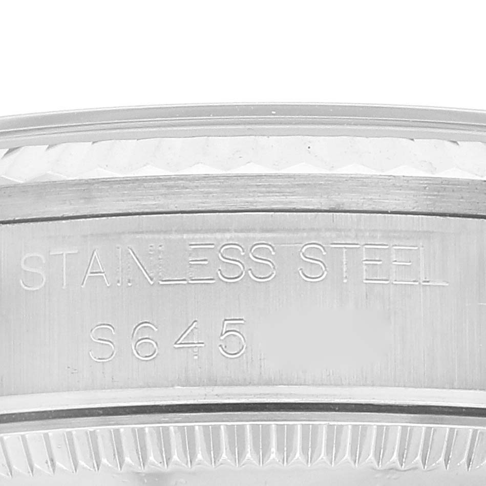 This close-up image shows the side of the stainless steel casing for a Rolex Mid-Size 68274 Women
s Stainless Steel Silver Dial 68274 Women
s Stainless Steel Silver Dial watch, featuring engraved text.