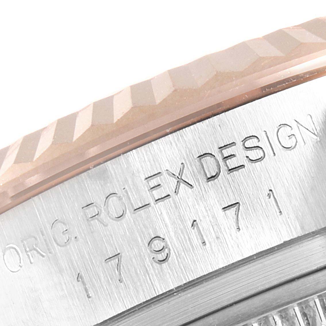 This close-up image shows the engraved bezel and part of the case of a Rolex Datejust 179171 Women's Steel and Gold (two tone) Black Dial 179171 Women's Steel and Gold (two tone) Black Dial watch.