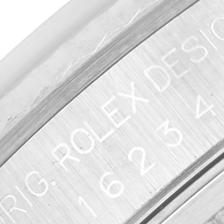 This image shows a close-up of the engraved side of a Rolex Datejust 16234 Men's Stainless Steel Silver Dial 16234 Men's Stainless Steel Silver Dial watch case.
