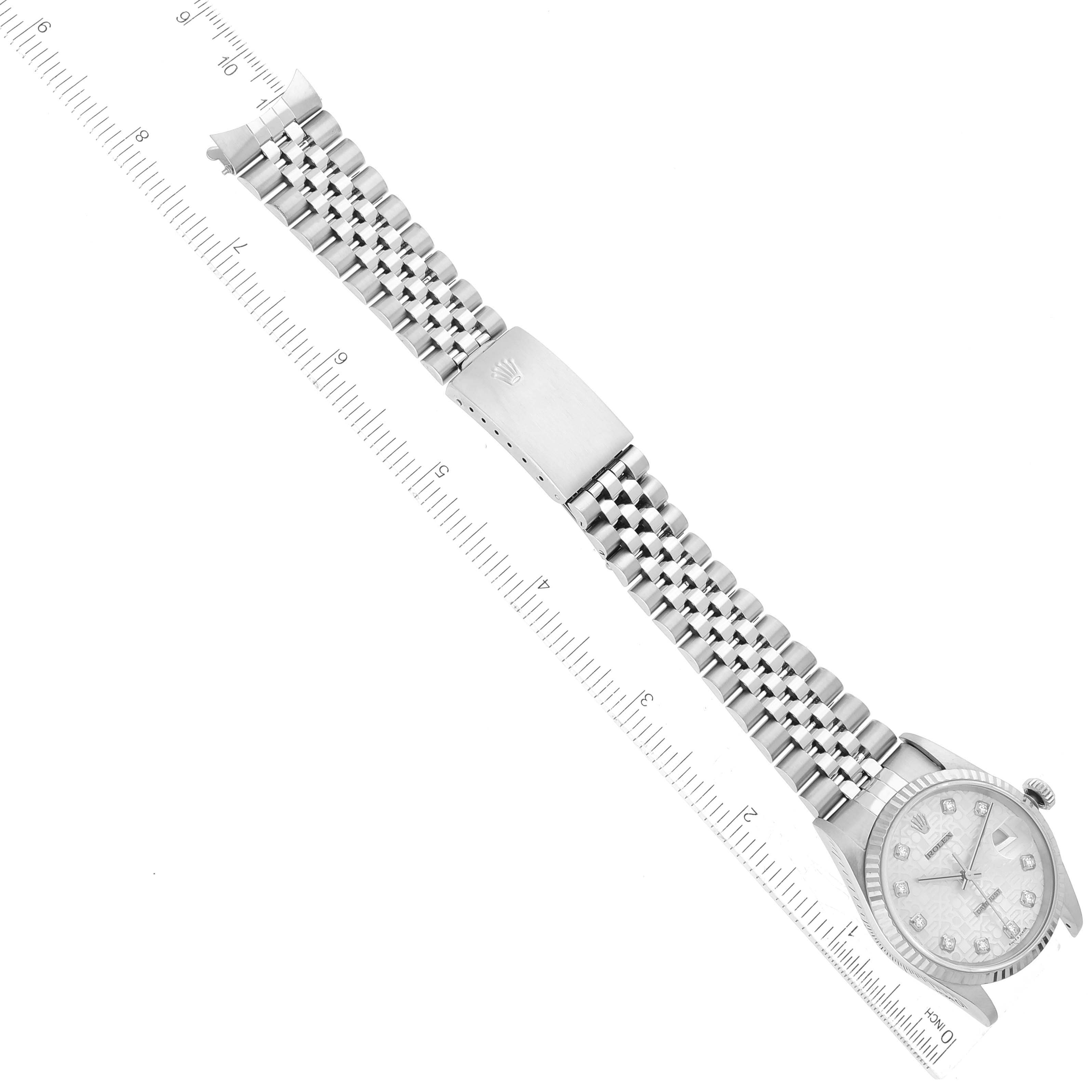 The image shows a top-down view of a Rolex Datejust 16234 Men's Stainless Steel Silver Dial 16234 Men's Stainless Steel Silver Dial watch, featuring the face, bezel, and bracelet with a ruler for scale.