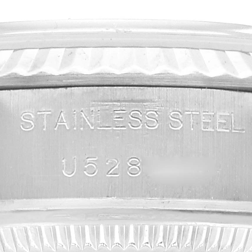 This is a close-up of the stainless steel casing with inscriptions on a Rolex Datejust 69174 Women's Stainless Steel White Dial 69174 Women's Stainless Steel White Dial watch.