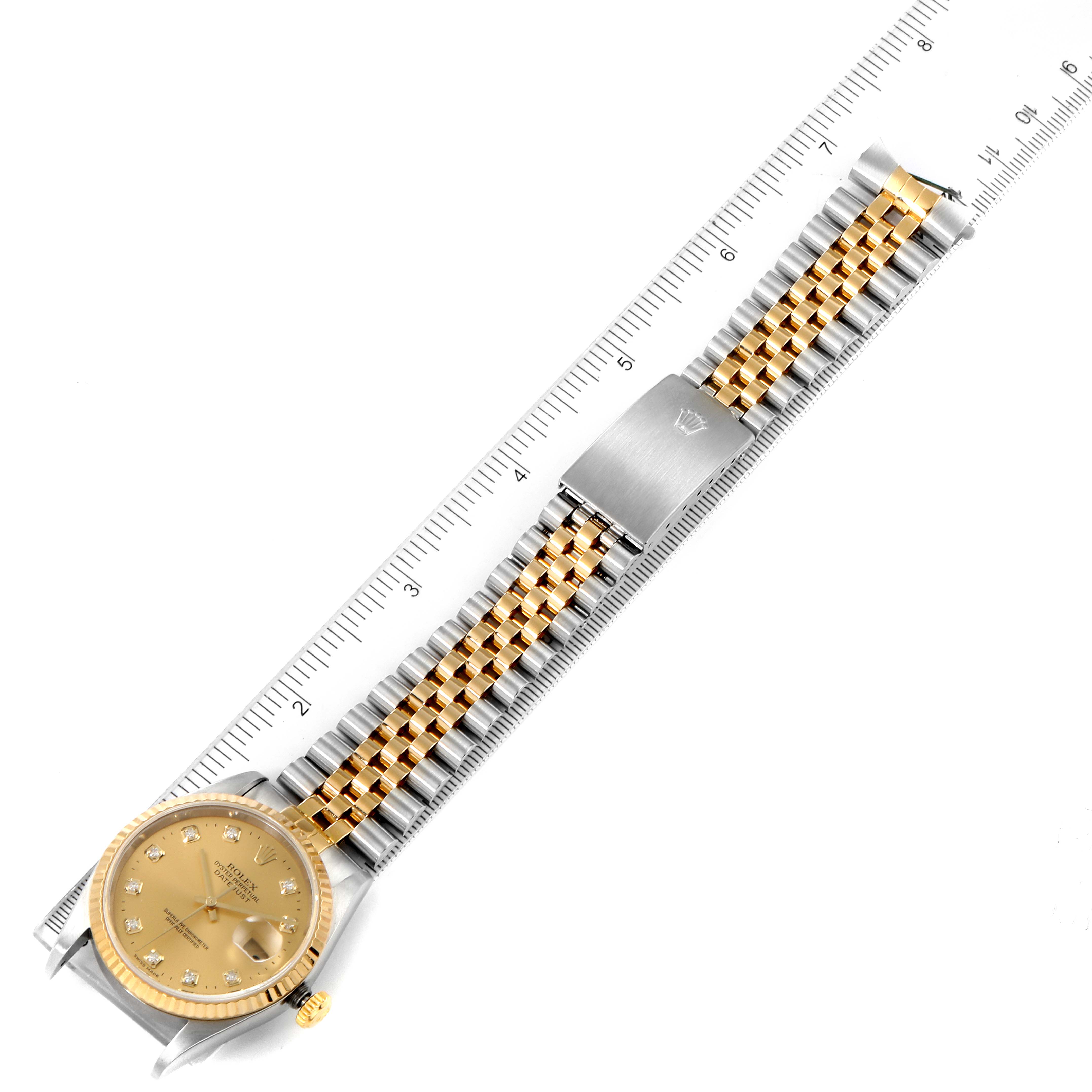 The image shows a top-down view of a Rolex Datejust 16233 Men's Steel and Gold (two tone) Champagne Dial 16233 Men's Steel and Gold (two tone) Champagne Dial watch with a gold and silver bracelet, alongside a ruler for scale.