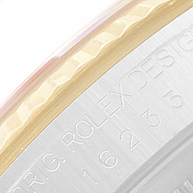 The image shows a close-up view of the bezel and casing of a Rolex Datejust 16233 Men's Steel and Gold (two tone) Champagne Dial 16233 Men's Steel and Gold (two tone) Champagne Dial watch with visible engravings.