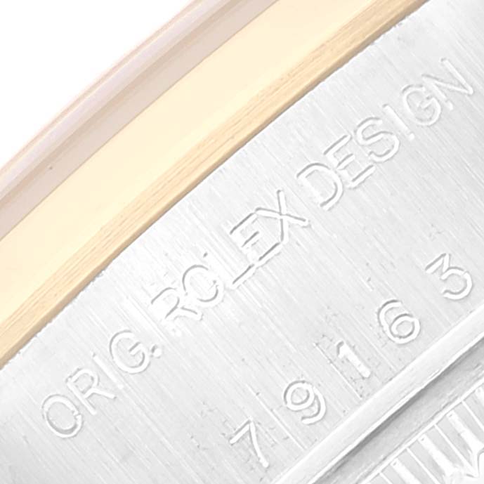 This image shows a close-up of the serial number and "ROLEX DESIGN" engraving on the case of a Rolex Datejust 79163 Women's Steel and Gold (two tone) Grey Dial 79163 Women's Steel and Gold (two tone) Grey Dial watch.
