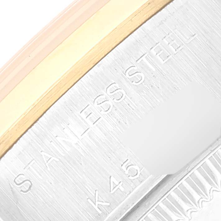 This close-up image shows the side engravings and stainless steel of the Rolex Datejust 79163 Women's Steel and Gold (two tone) Grey Dial 79163 Women's Steel and Gold (two tone) Grey Dial watch bezel.