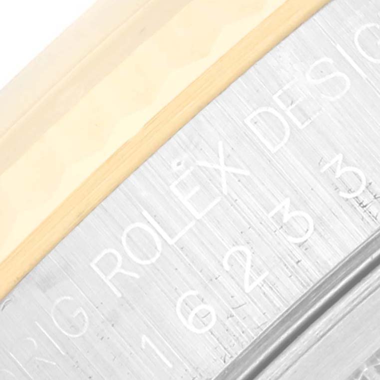 This is a close-up of the inner bezel and part of the dial of a Rolex Datejust 16233 Men's Steel and Gold (two tone) White Dial 16233 Men's Steel and Gold (two tone) White Dial watch showing the engraved branding and model details.