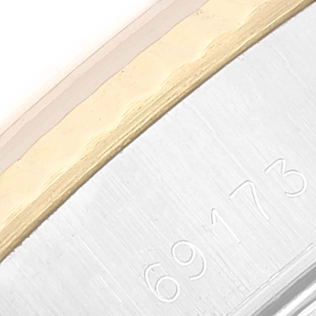 This image shows a close-up of the side of a Rolex Datejust 69173 Women's Steel and Gold (two tone) White Dial 69173 Women's Steel and Gold (two tone) White Dial watch, displaying part of its two-tone bezel and the model number engraved.