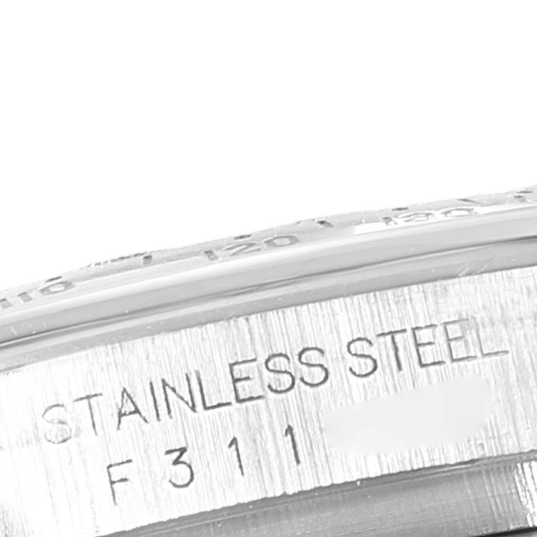 This close-up image shows the engraved stainless steel case with serial number of a Rolex Daytona 116520 Men's Stainless Steel Black Dial 116520 Men's Stainless Steel Black Dial watch.