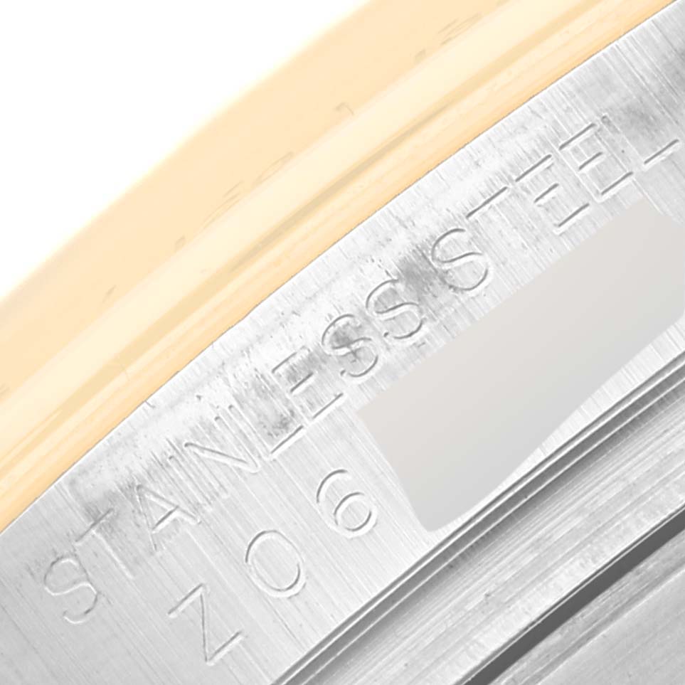 This image shows a close-up of the stainless steel part of a Rolex Daytona 116523G Men
s Steel and Gold (two tone) White Dial 116523G Men
s Steel and Gold (two tone) White Dial watch.