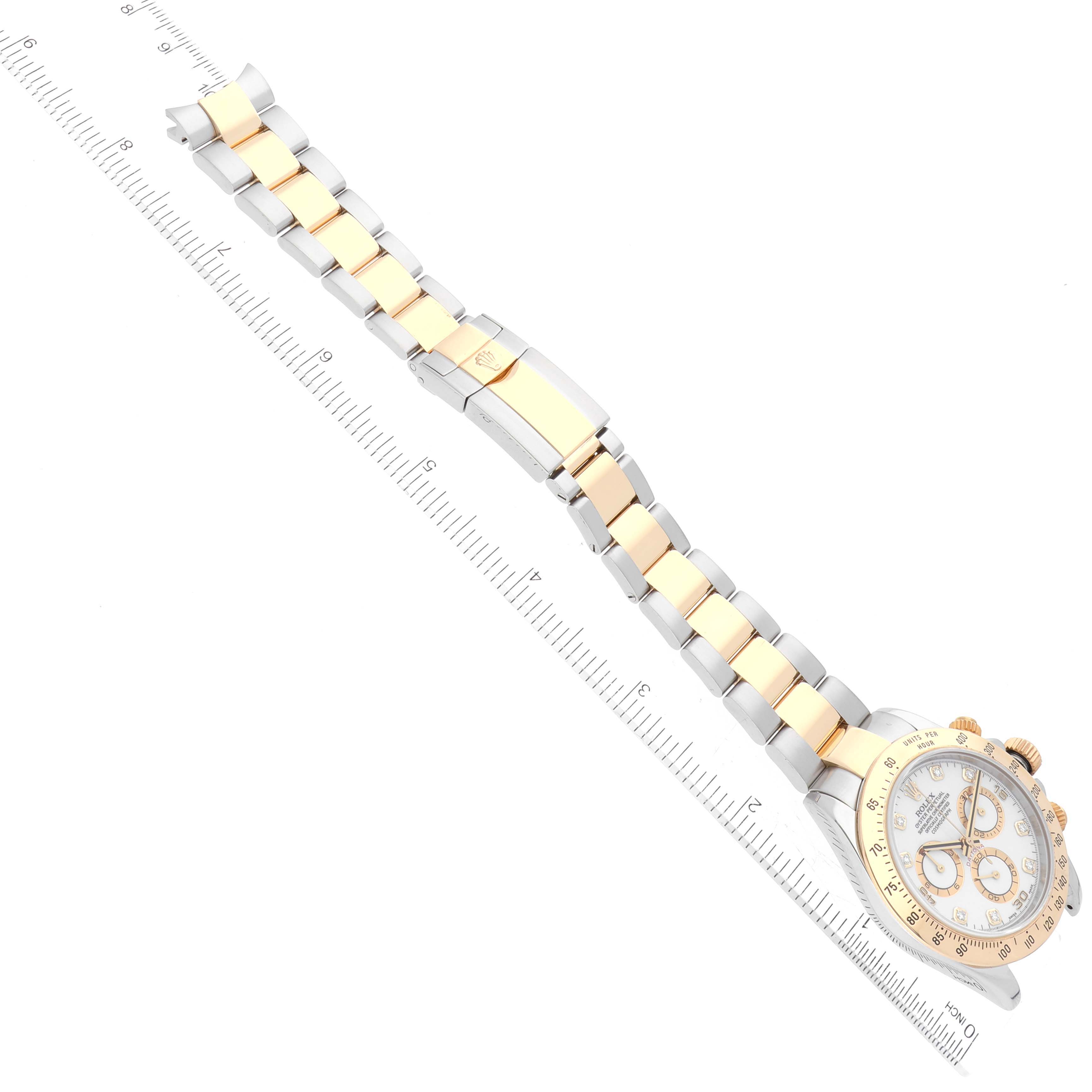 The image shows a Rolex Daytona 116523G Men
s Steel and Gold (two tone) White Dial 116523G Men
s Steel and Gold (two tone) White Dial watch laid flat, with a clear view of its face, bezel, and bracelet at an angled top-down perspective.